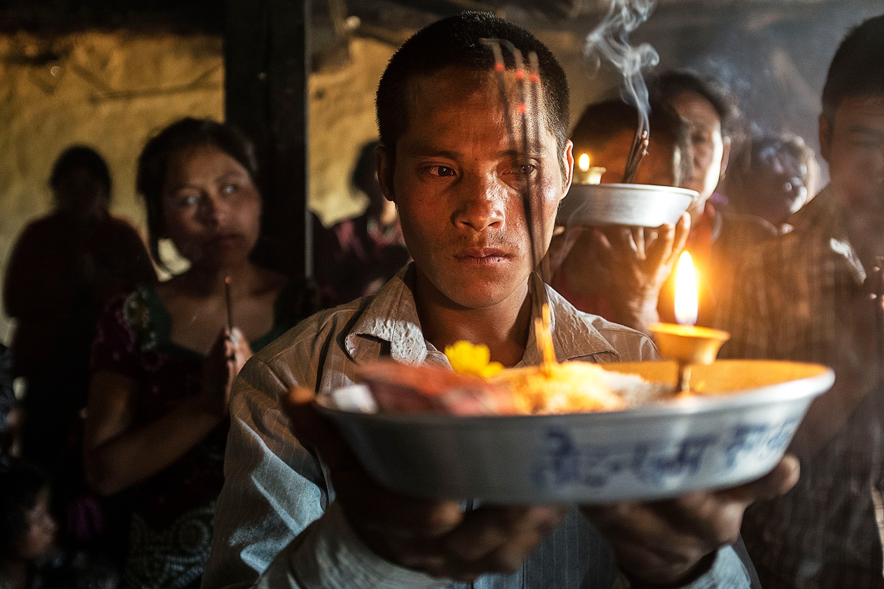 a young man carriying offering