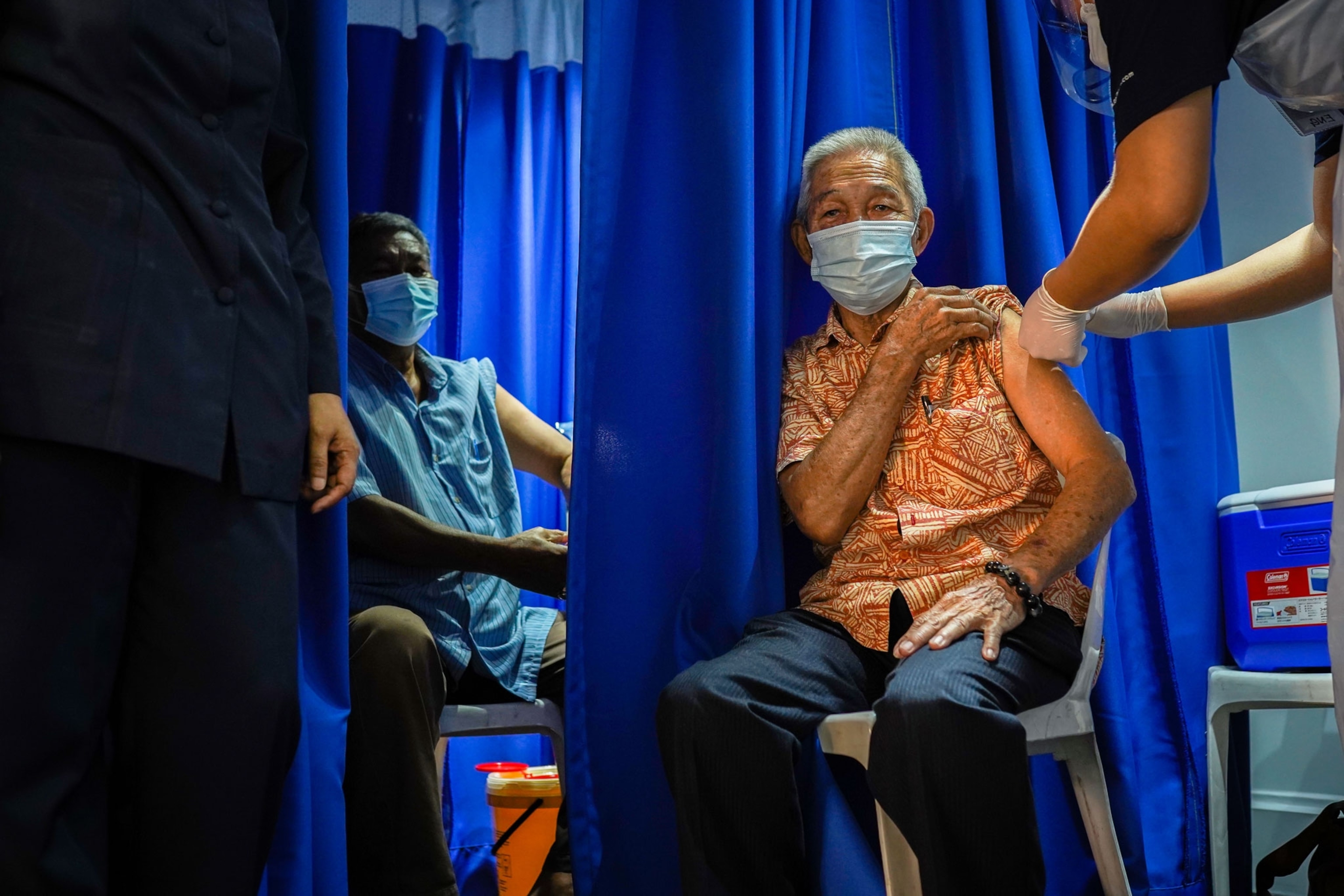 An elder man receives the Covid-19 vaccine in Kuala Lumpur.