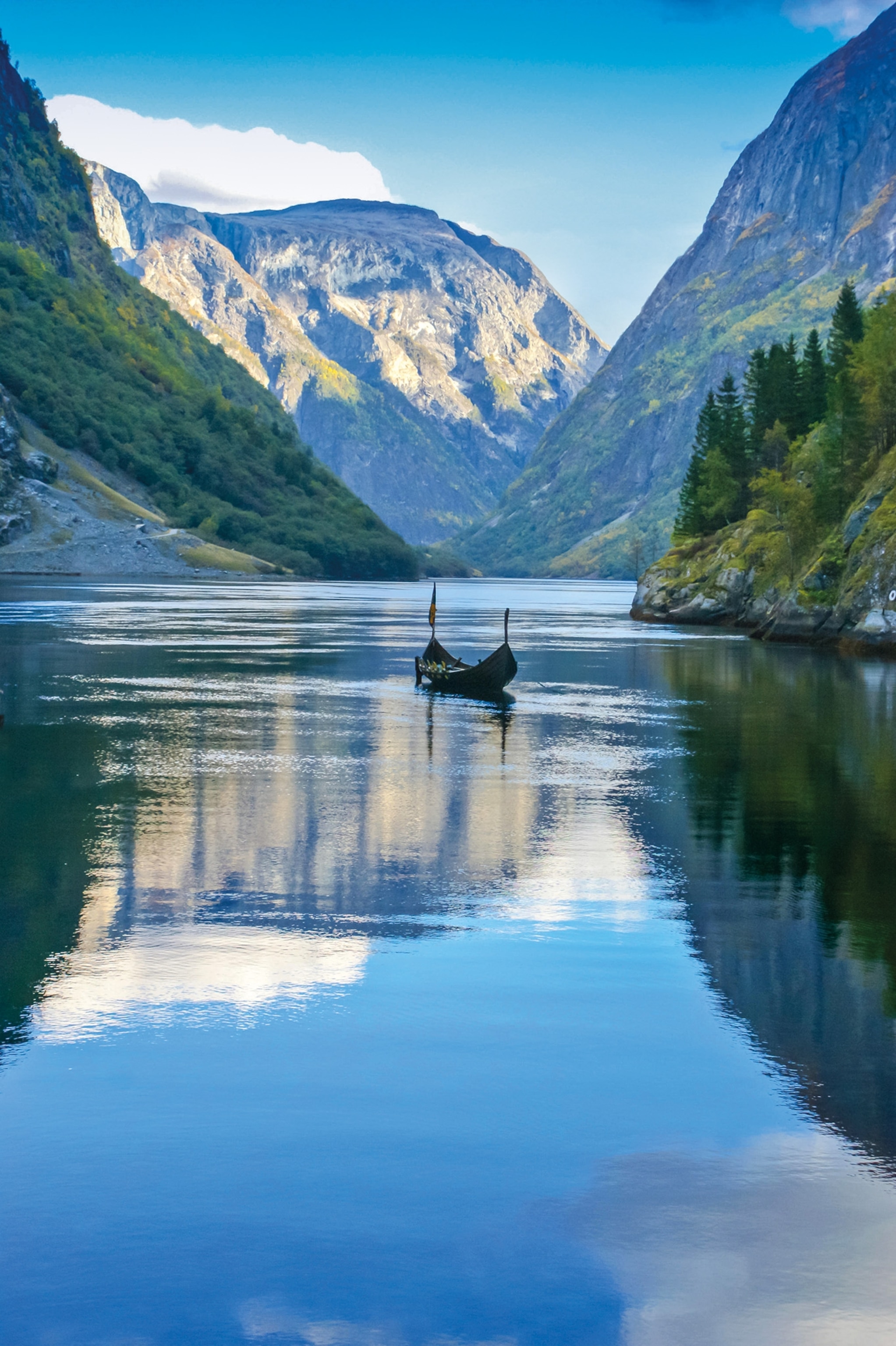 A replica of a Viking ship passes along the Sognefjorden, the deepest and longest fjord in Norway. Living in a landscape dominated by water, the Vikings of the Scandinavian peninsula became expert boatbuilders and navigators.