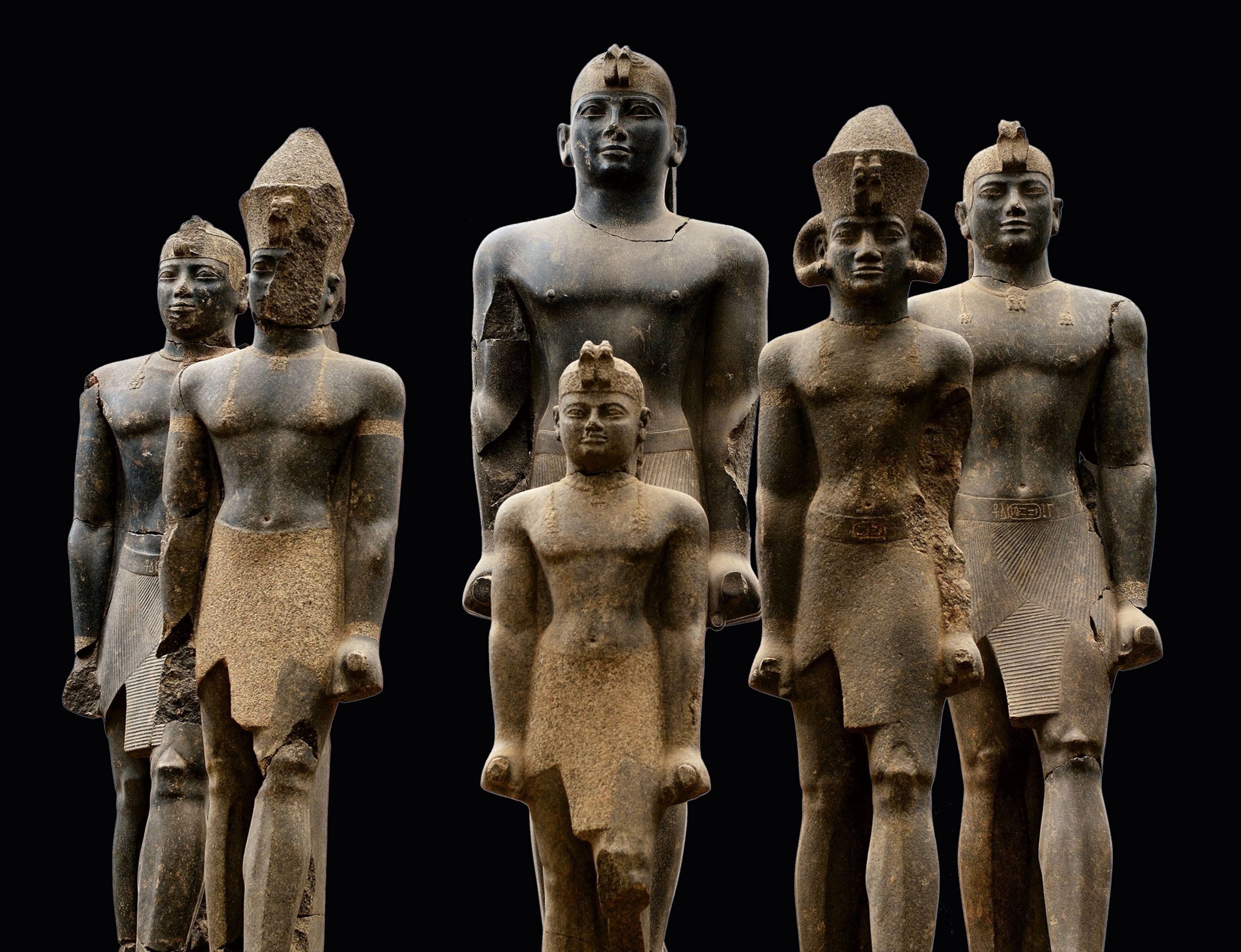 Six stone statues of kings stand all in a row