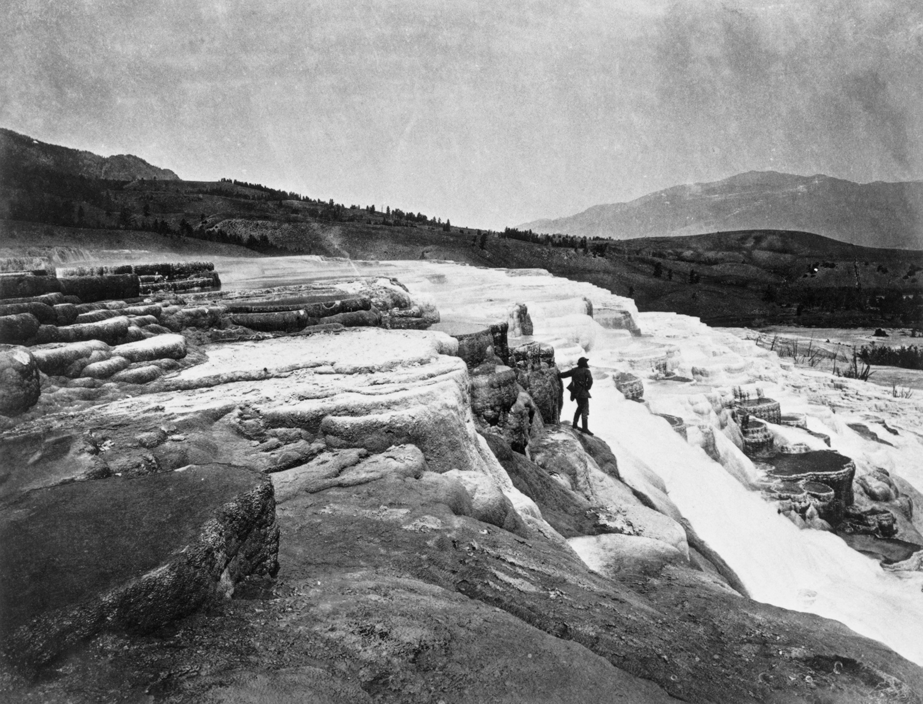 Archival photo of Thomas Moran, a landscapist, photographed at Mammoth Hot Springs. Jackson's photographs and Moran's sketches influenced Congress to name Yellowstone the first national park in 1872. Wyoming