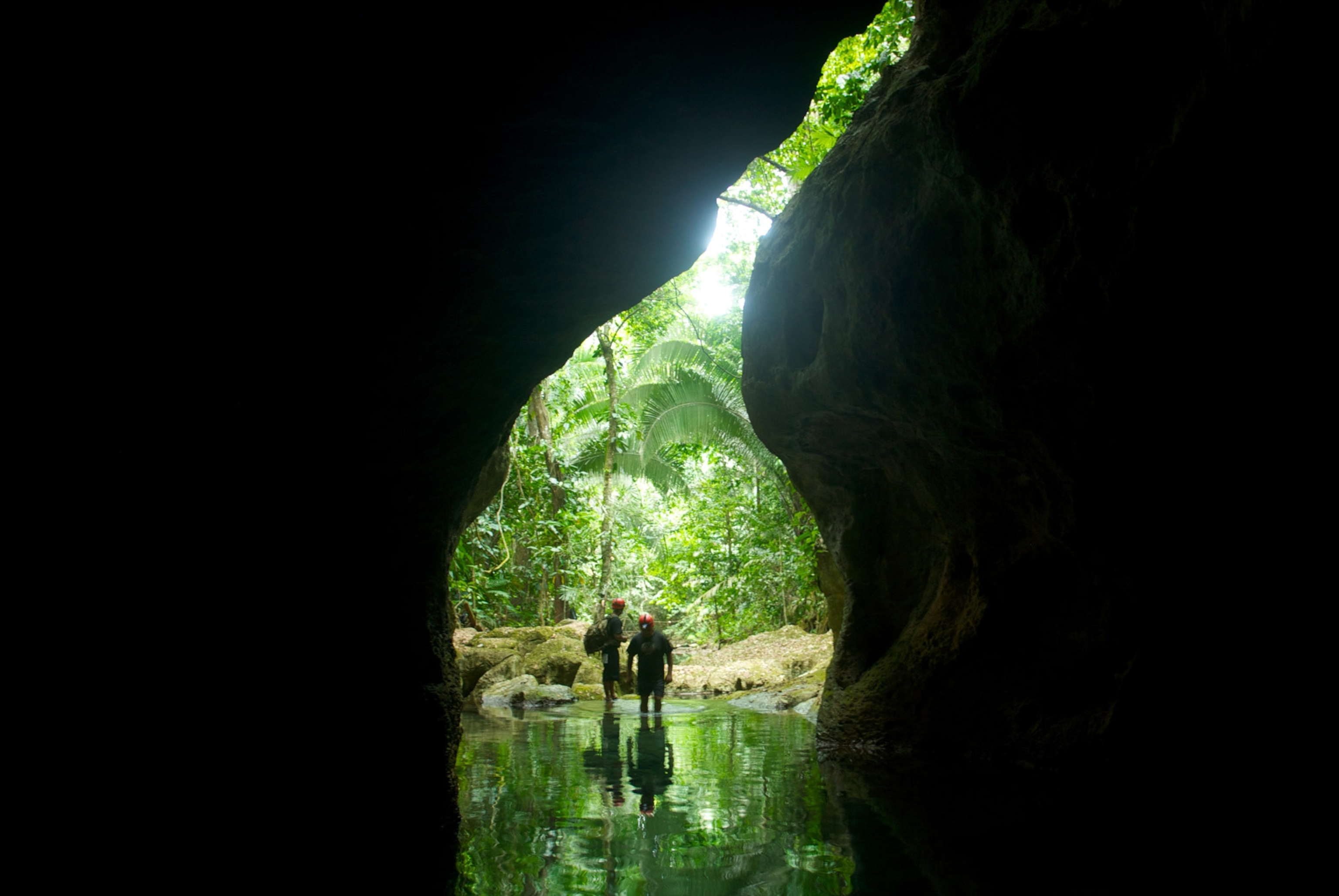 A cave outlines people ready to explore.