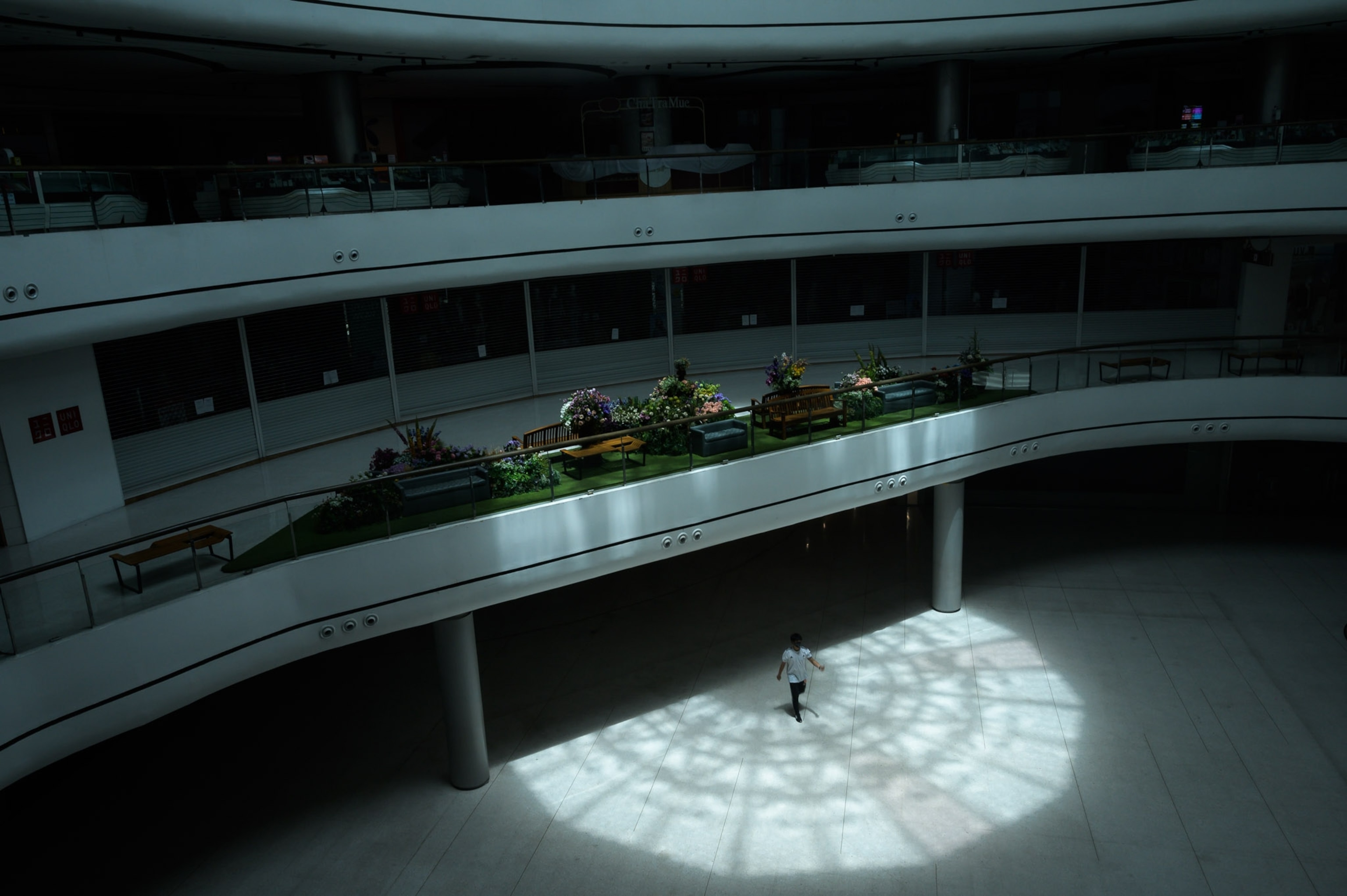 an empty department store with a single person walking through it