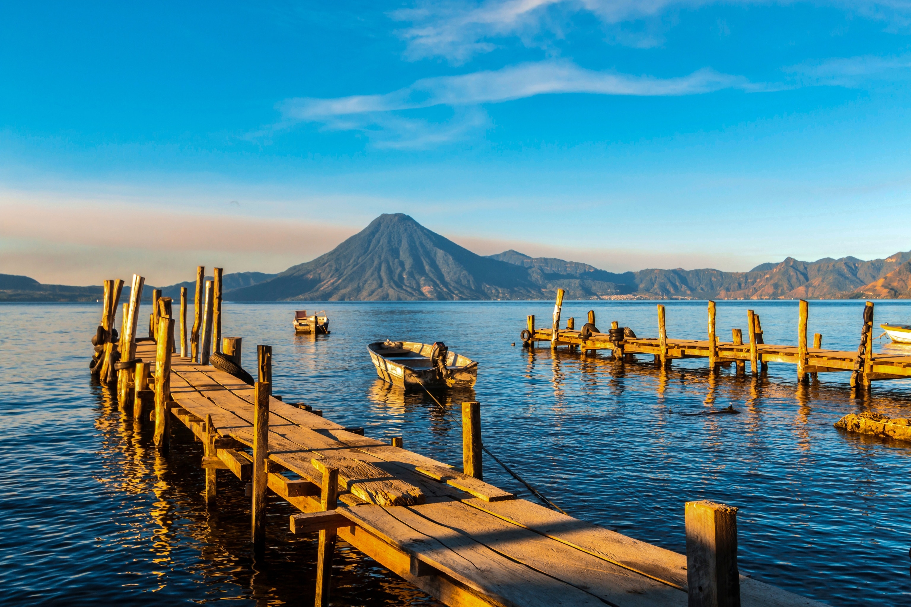 Lake Atitlán, with a volcano in the distance. Known for the conical volcanoes and Maya villages around its shores, the destination showcases Guatemala's dramatic nature and cultural heritage — two of the country's main draws.