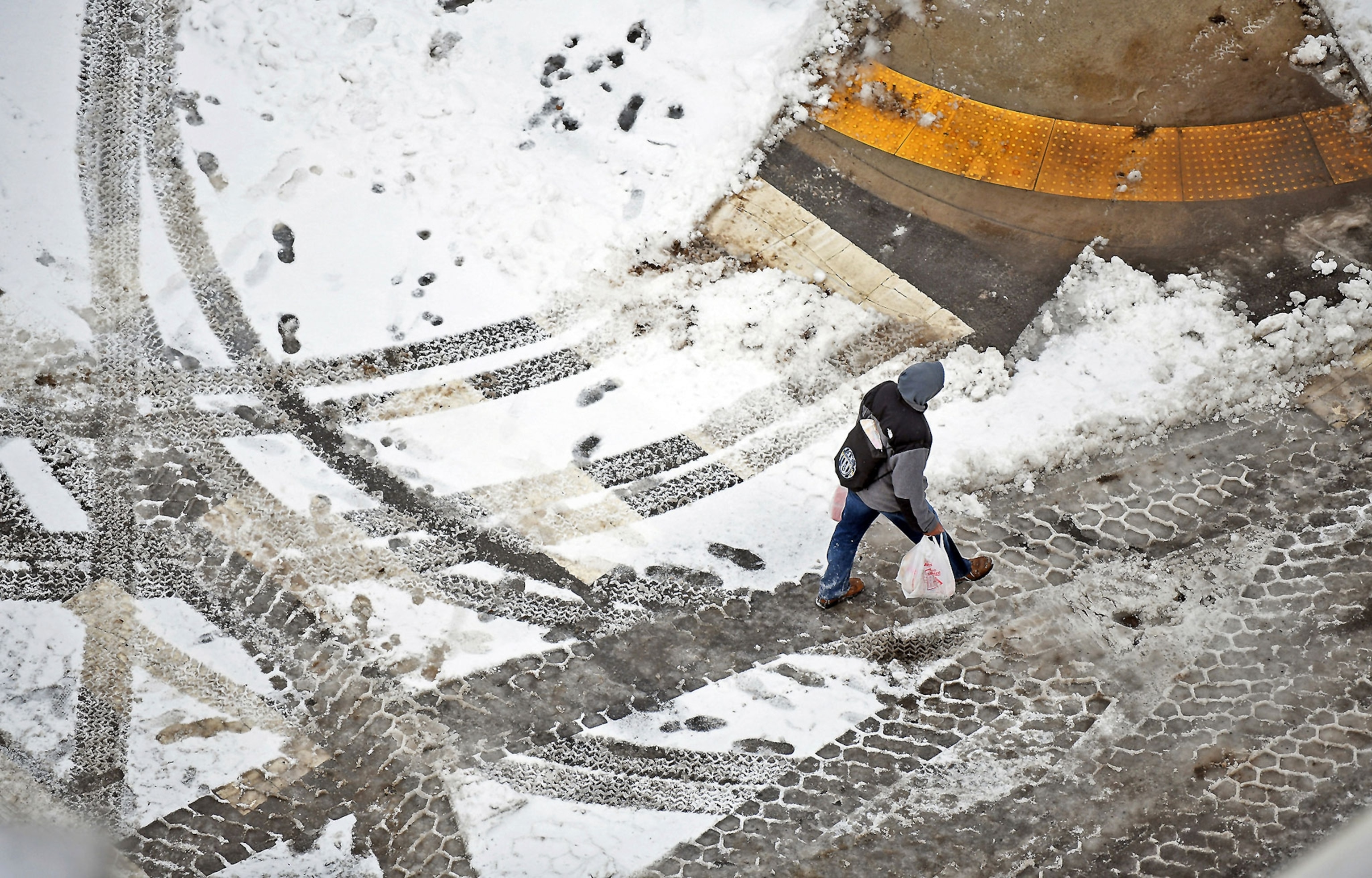 a pedestrian walking through slush