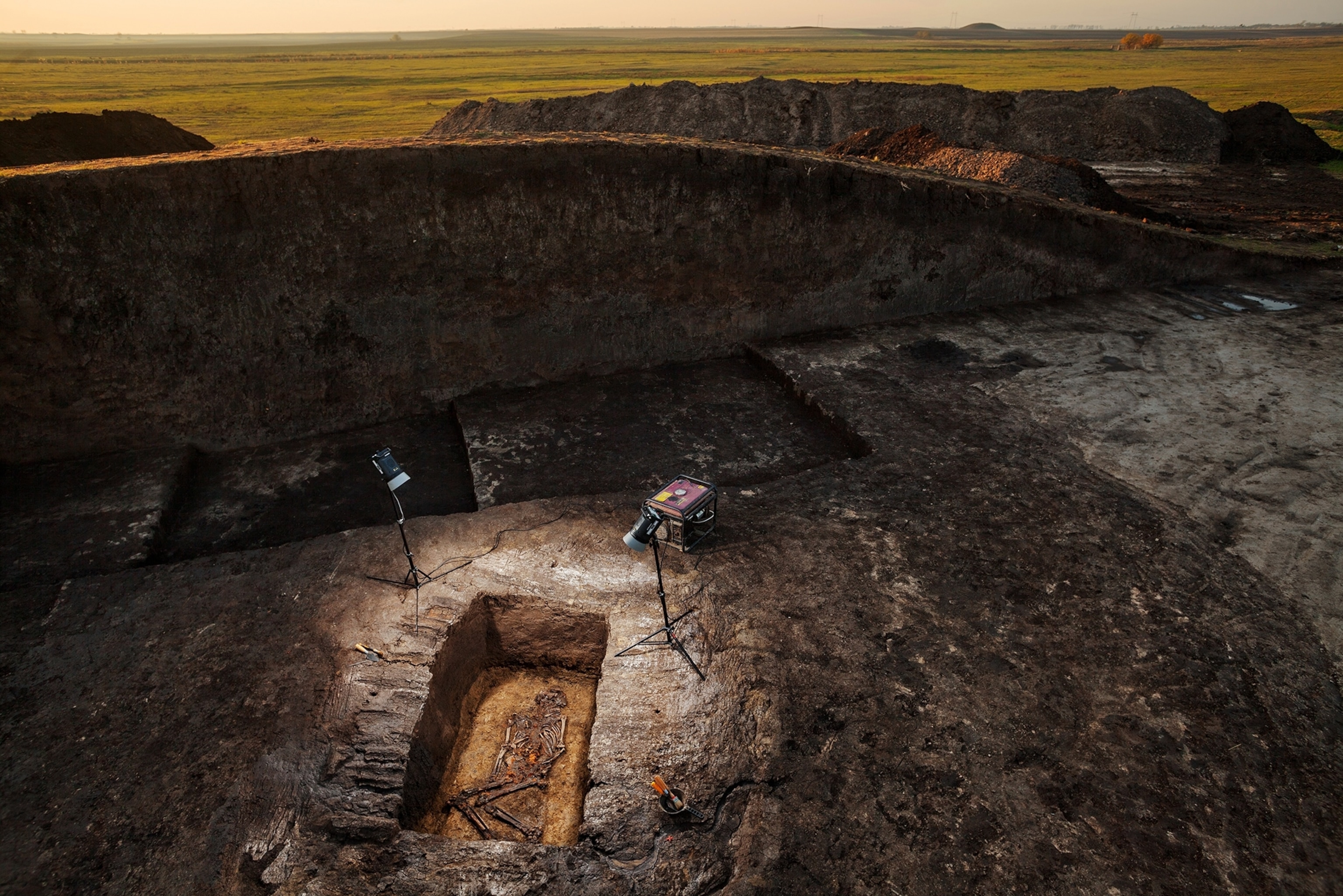 a rectangular grave with human skeleton in it.