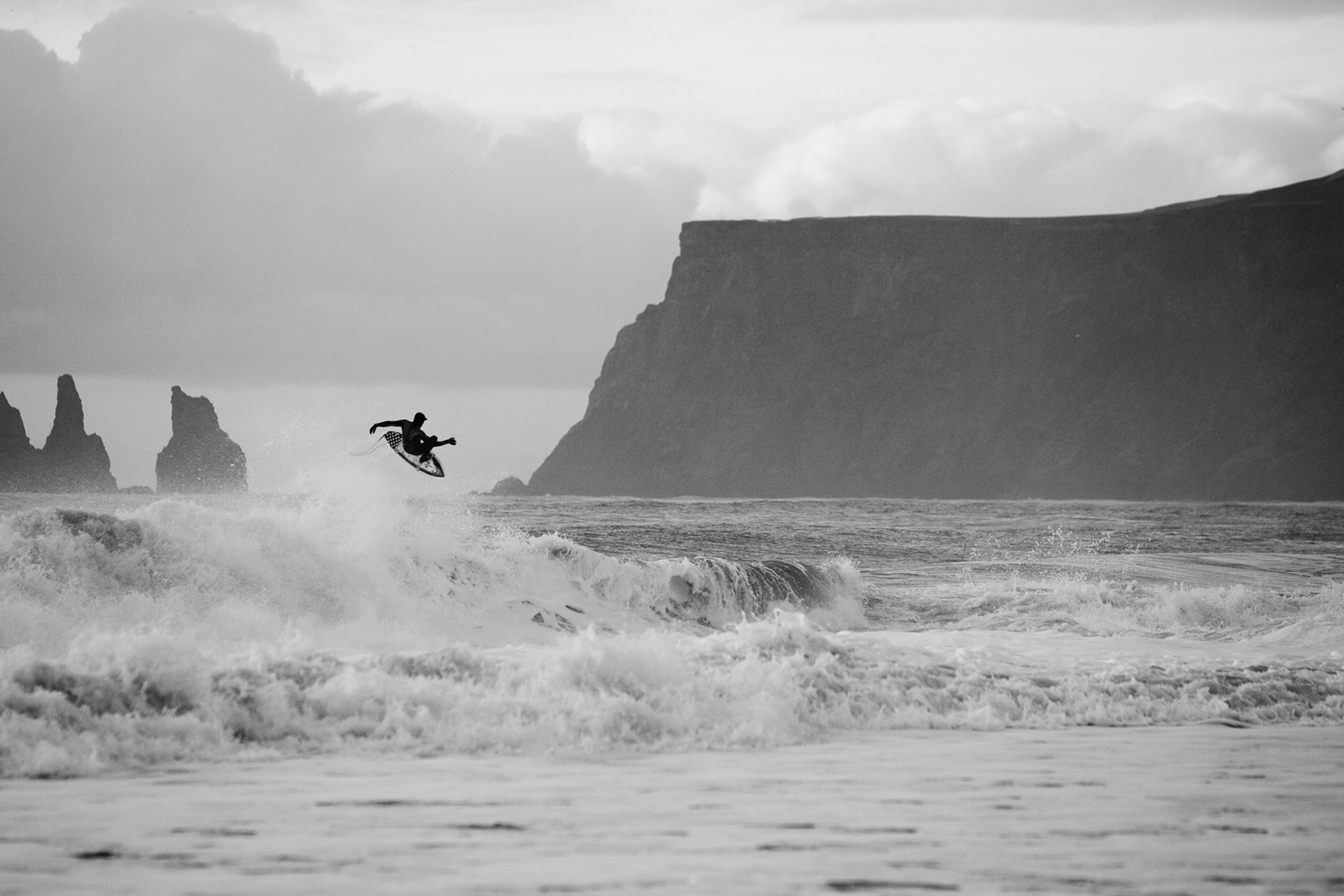 a surfer near Vik, Iceland