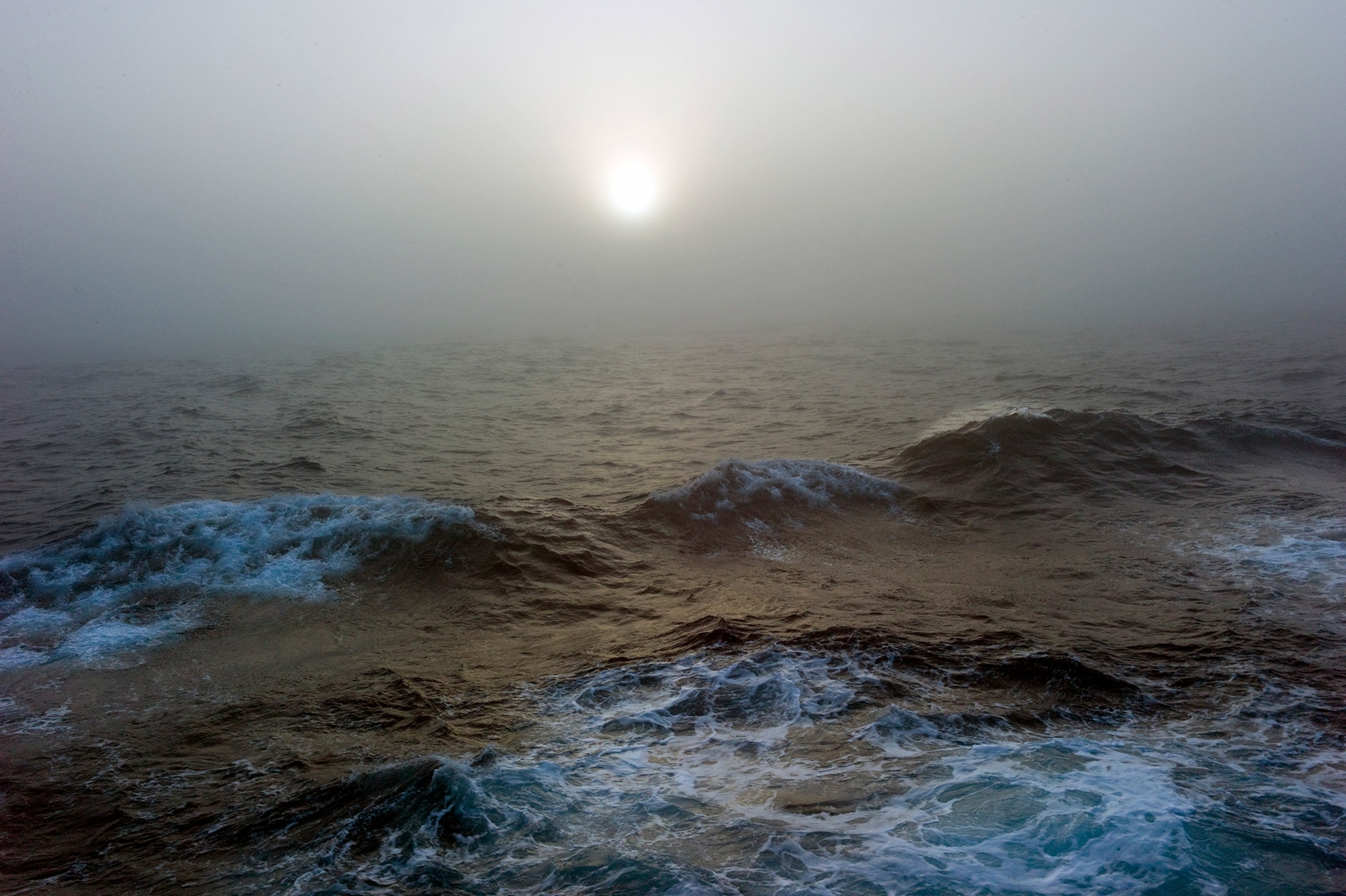 Choppy waters with fog and light.