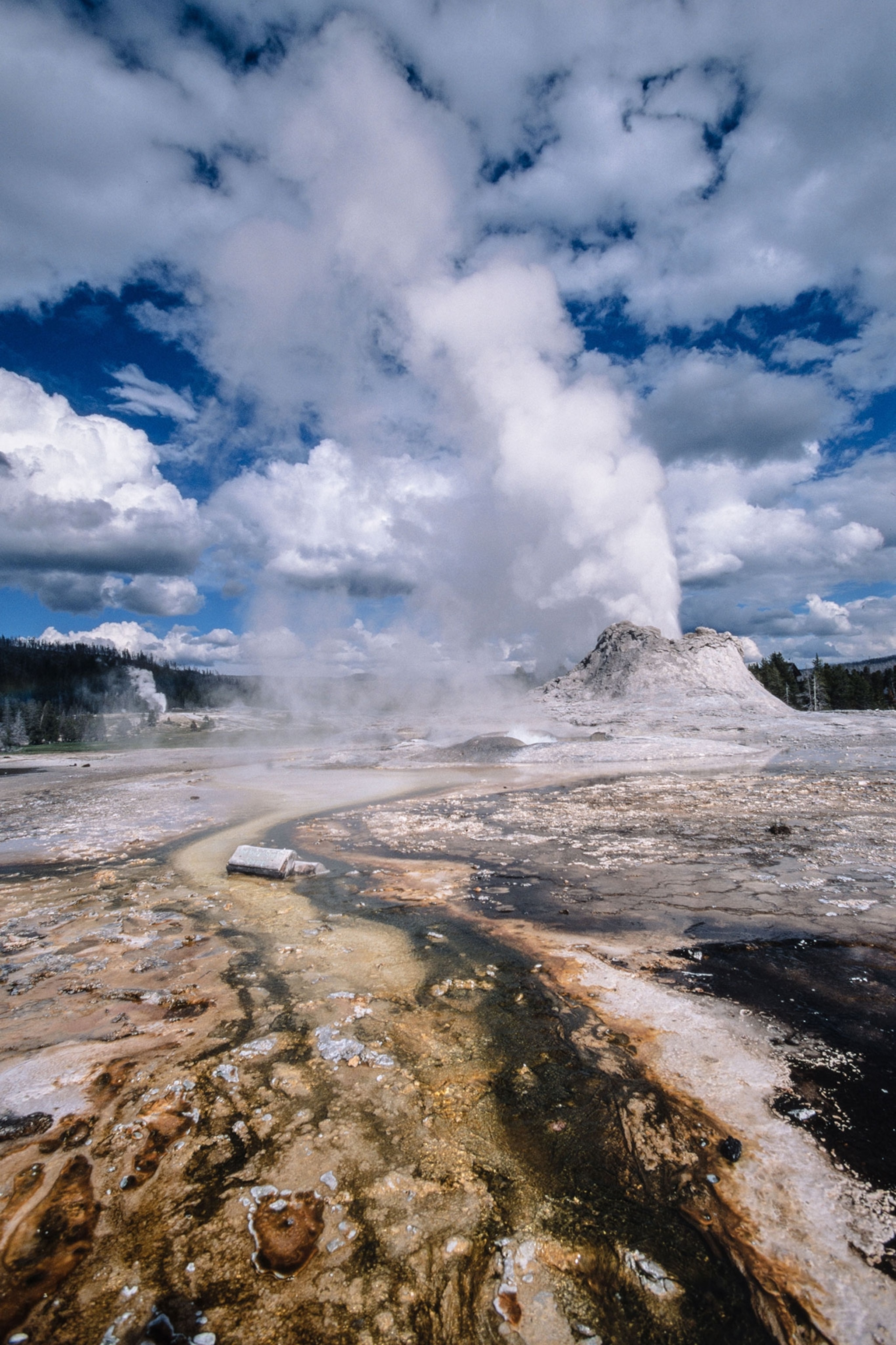Castle Geyser erupting steam and hot water.
