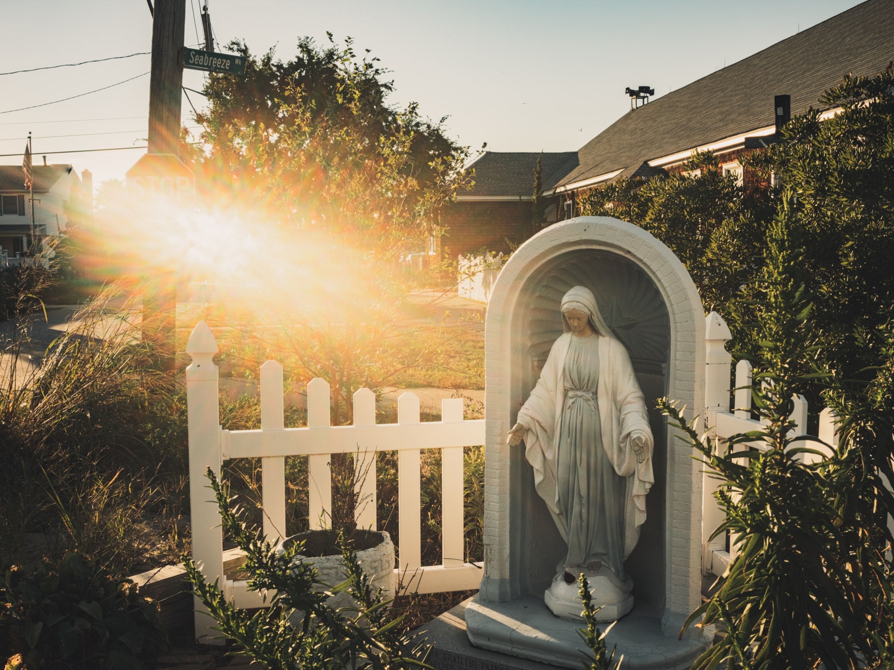 The Madonna Statue now sits on a stone plaque commemorating all those who helped the coastal community rebuild.