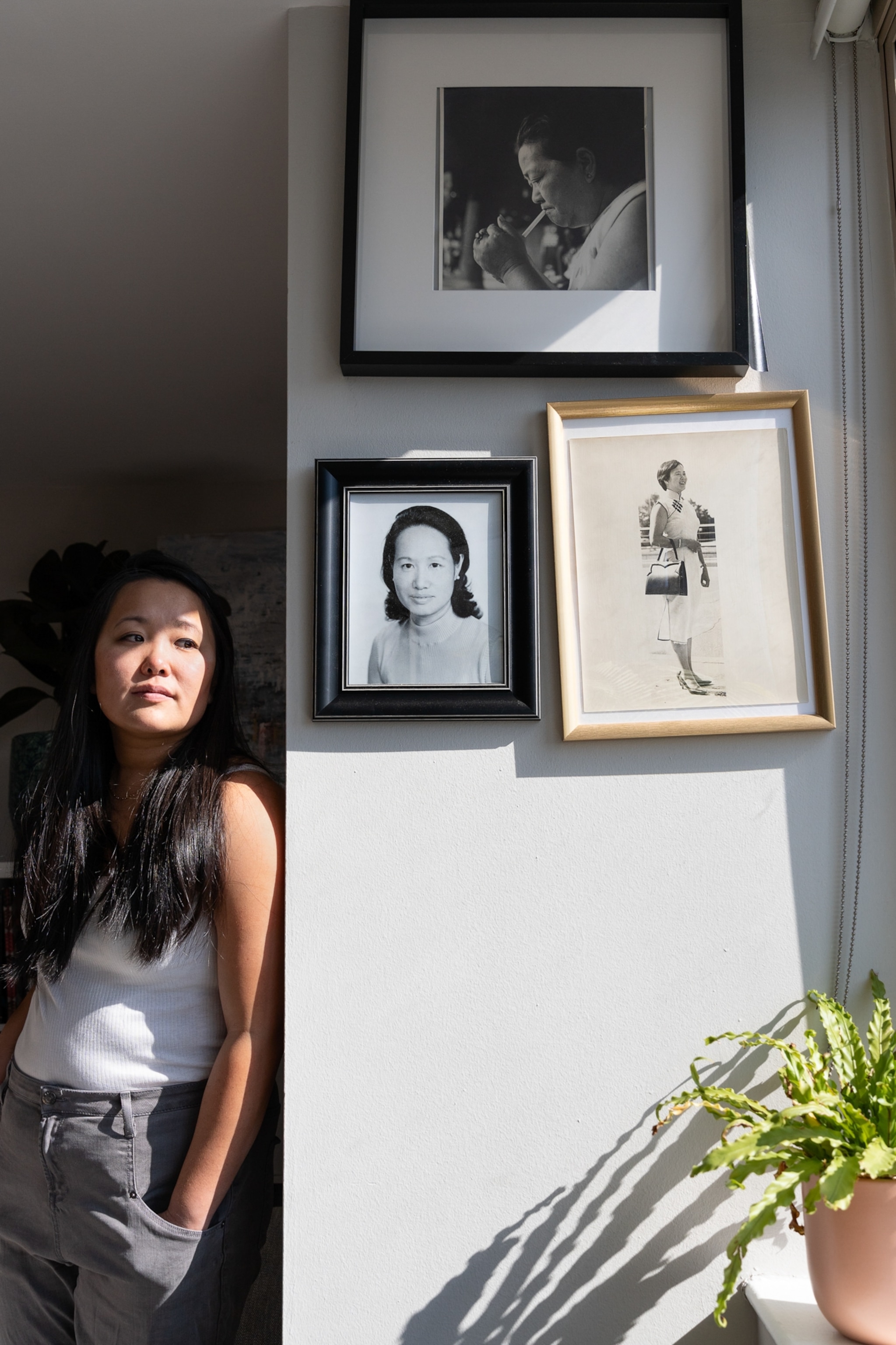 Andy stands by photographs of her grandmother and great-grandmother.