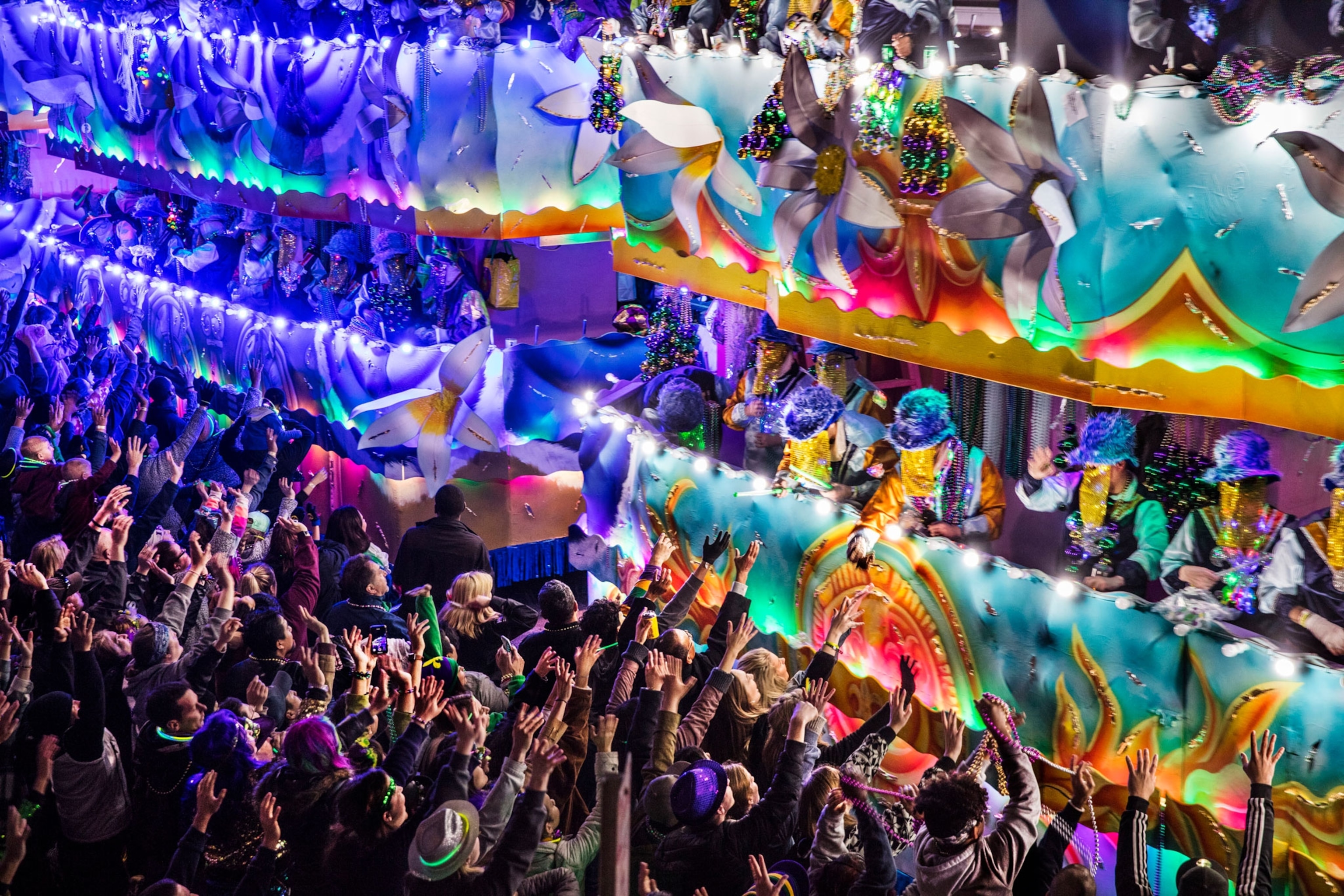 Crowds screaming for beads thrown from floats on the Endymion parade during Mardi Gras