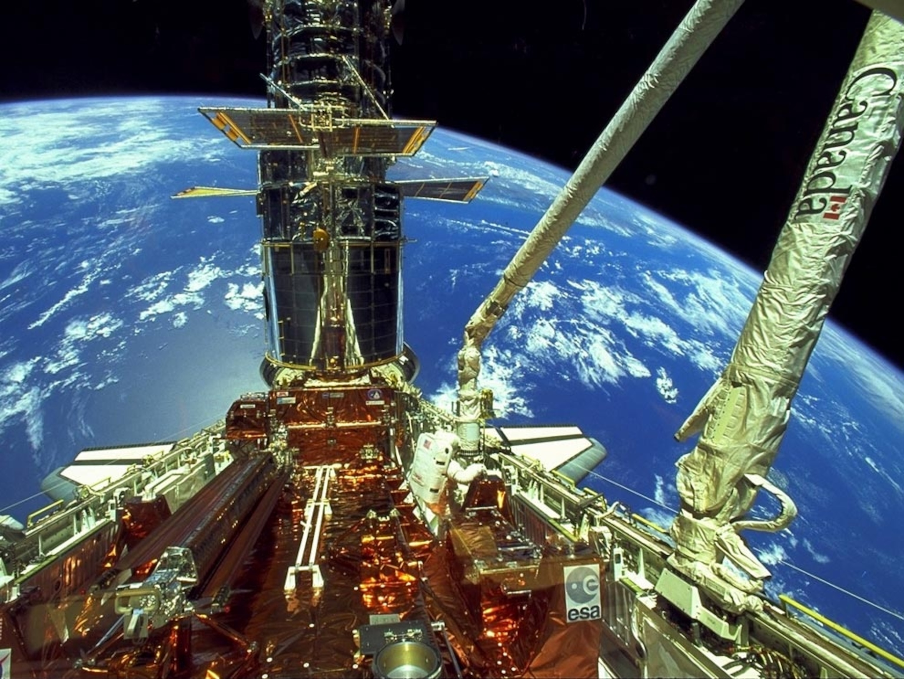 astronauts deploying Hubble's solar arrays