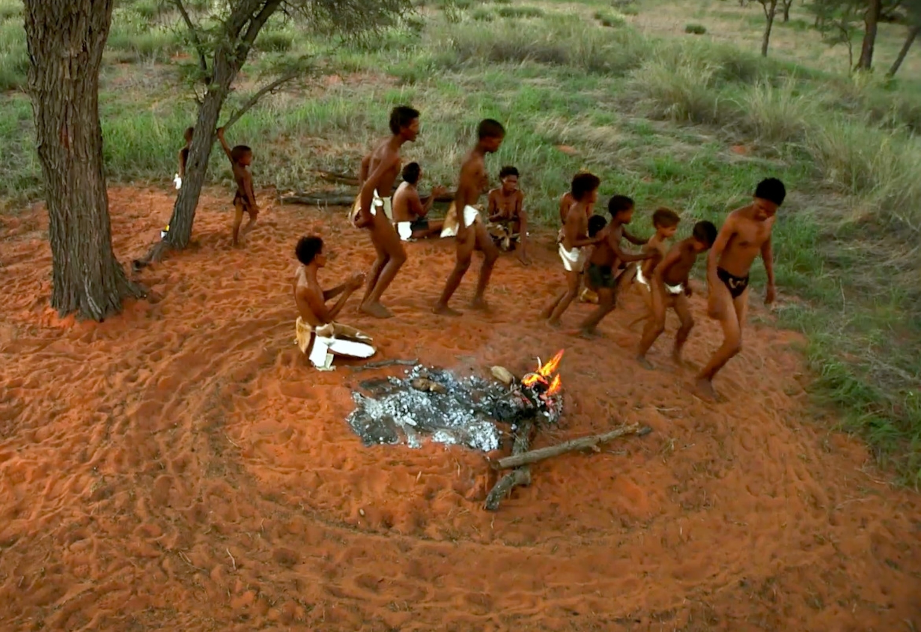 people dancing around fire in the ǂKhomani Cultural Landscape