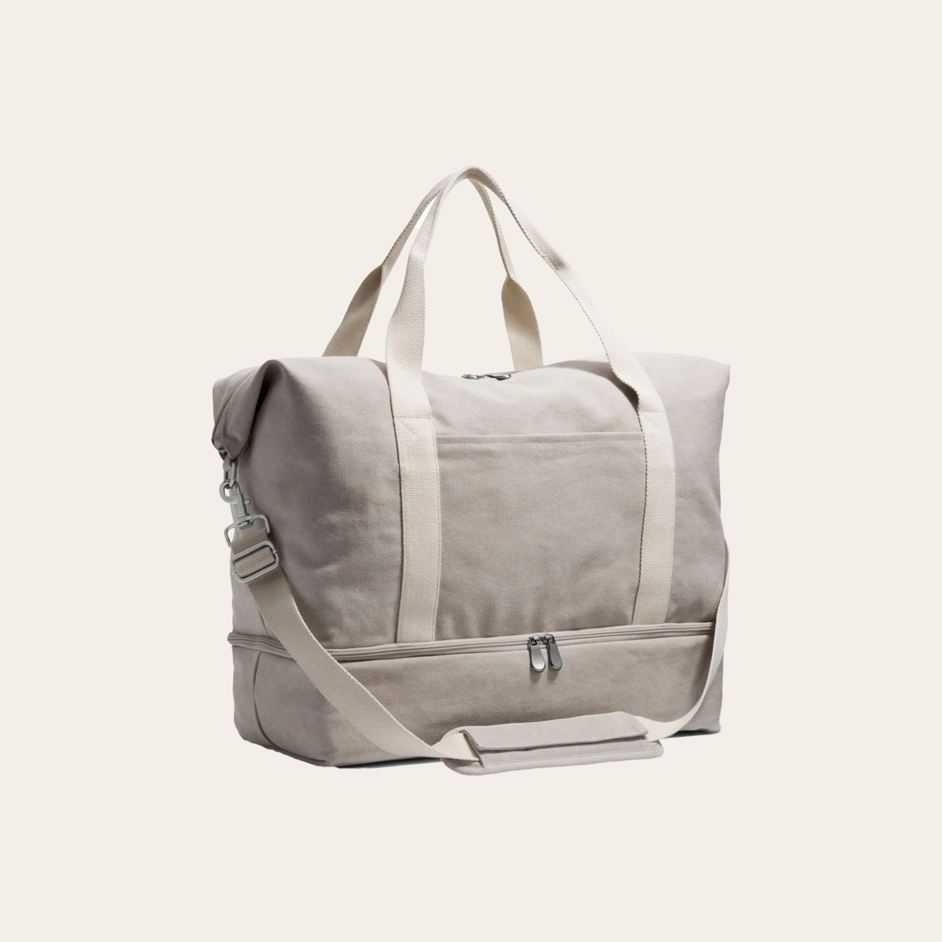 A grey tote bag with shoulder strap against a tan background.