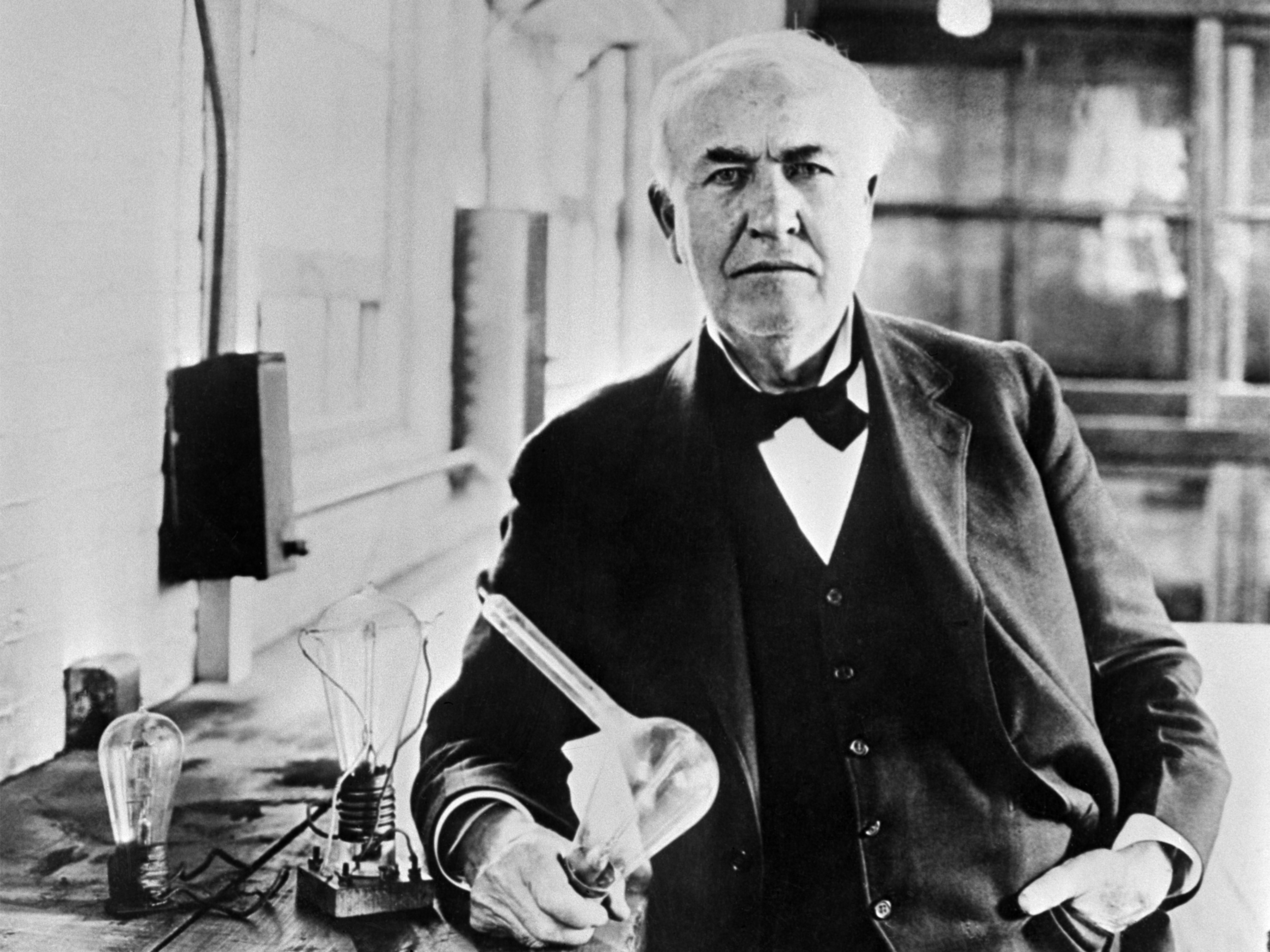 American inventor Thomas Edison with a light bulb.
