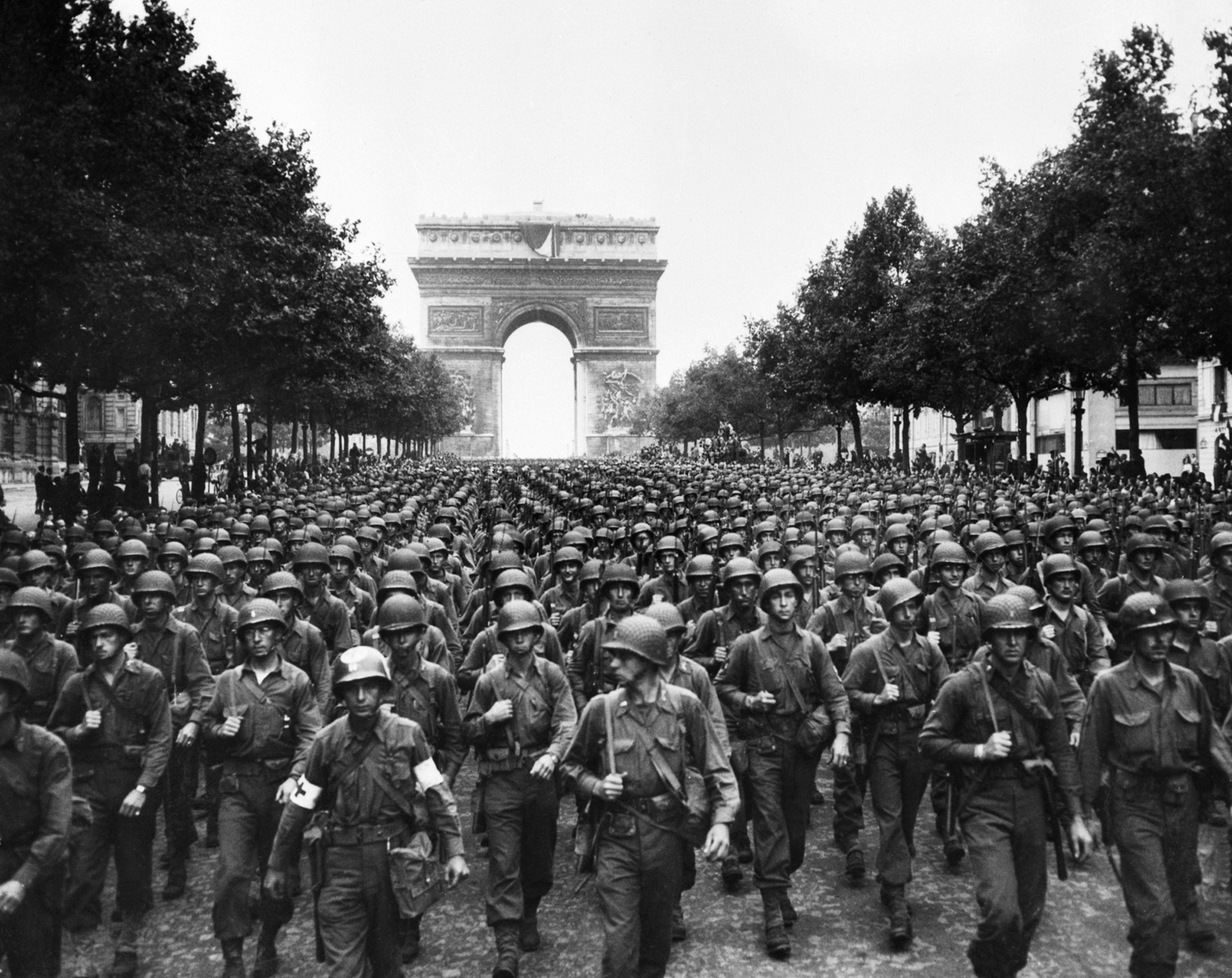 Troops fill the streets of Paris a black and white image.