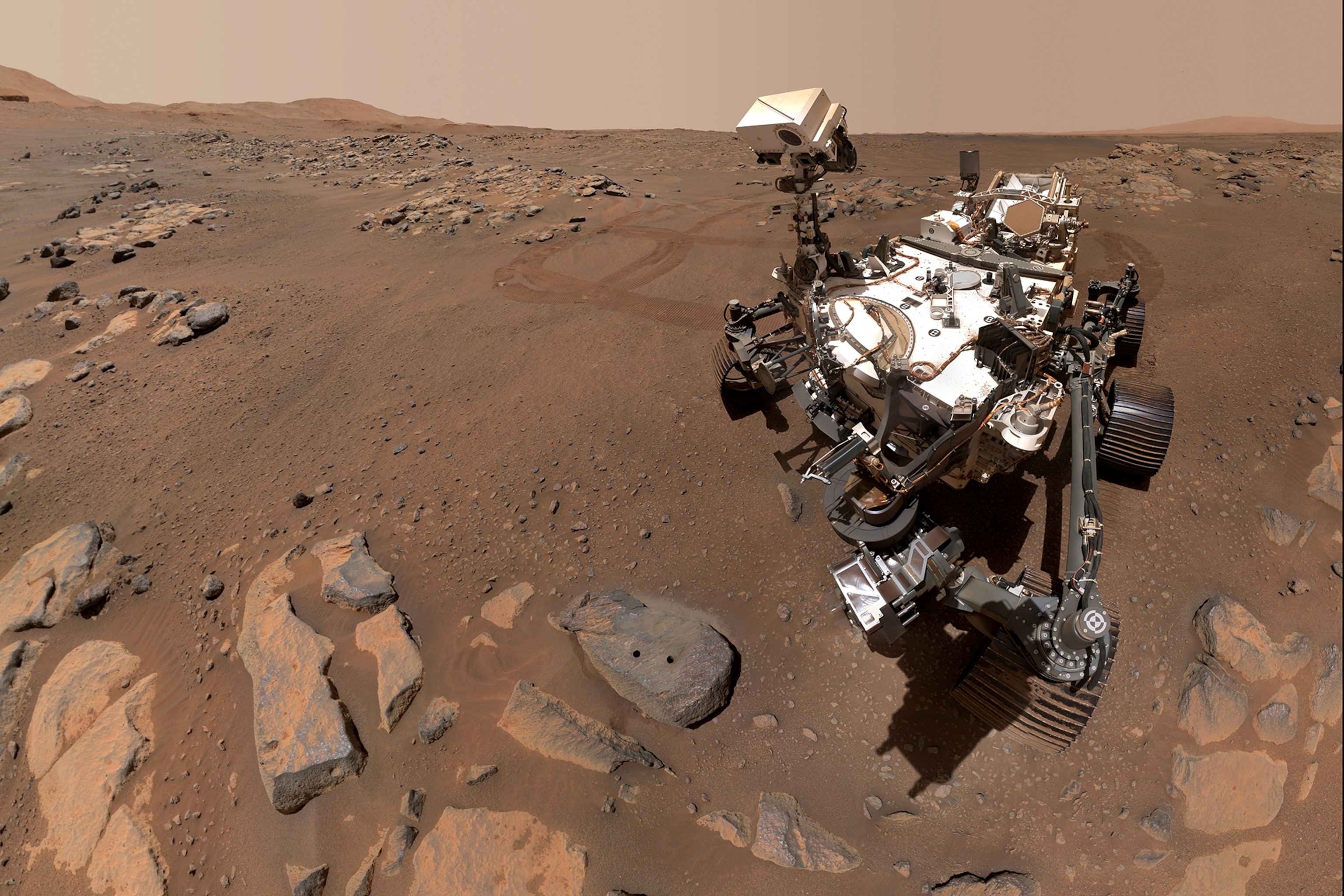 Picture of Perseverance Mars rover and two holes can be seen where the rover used its robotic arm to drill rock core samples.