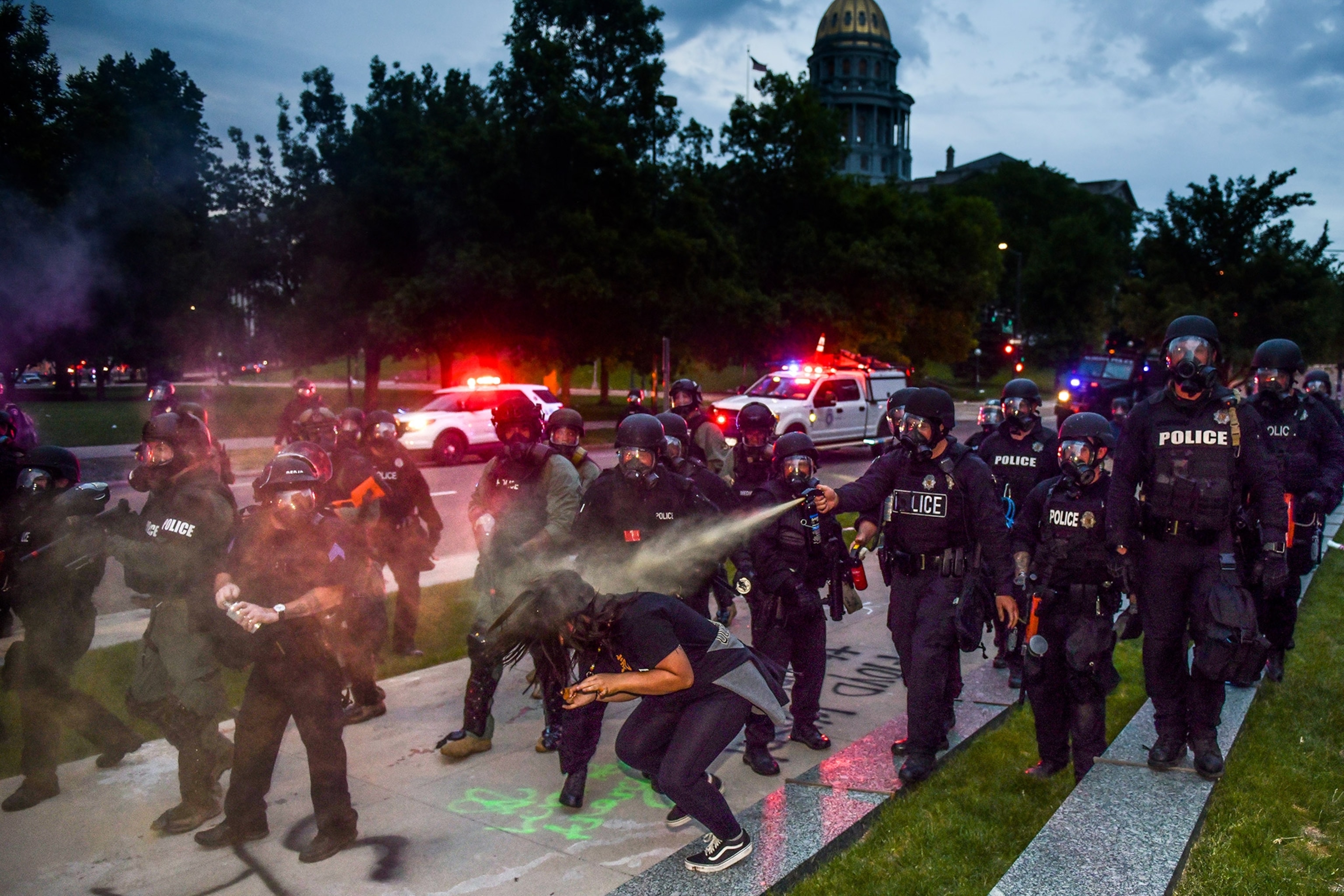 police officers using pepper spray on a woman in Denver, Colorado