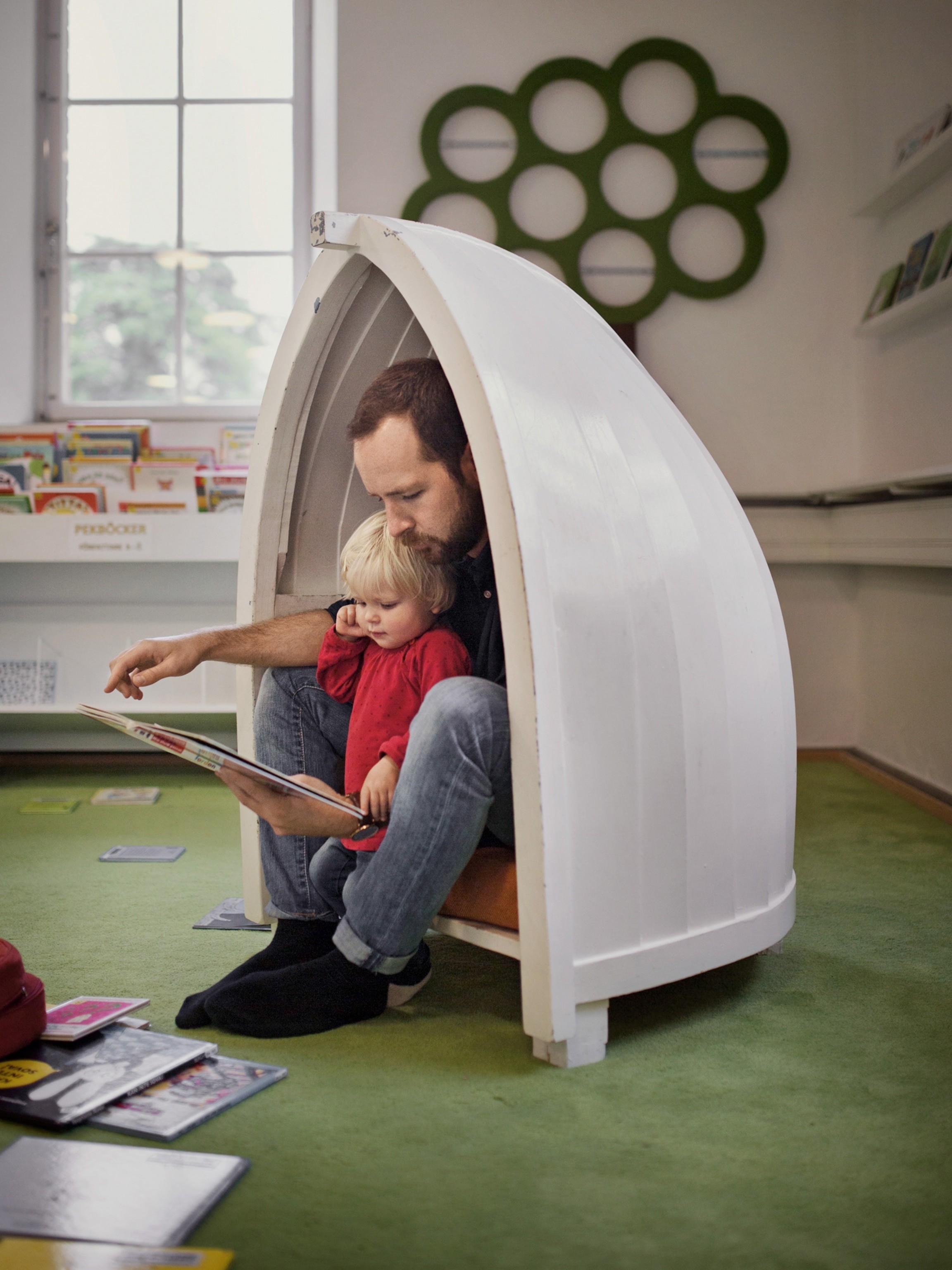 a father reading a book with his child