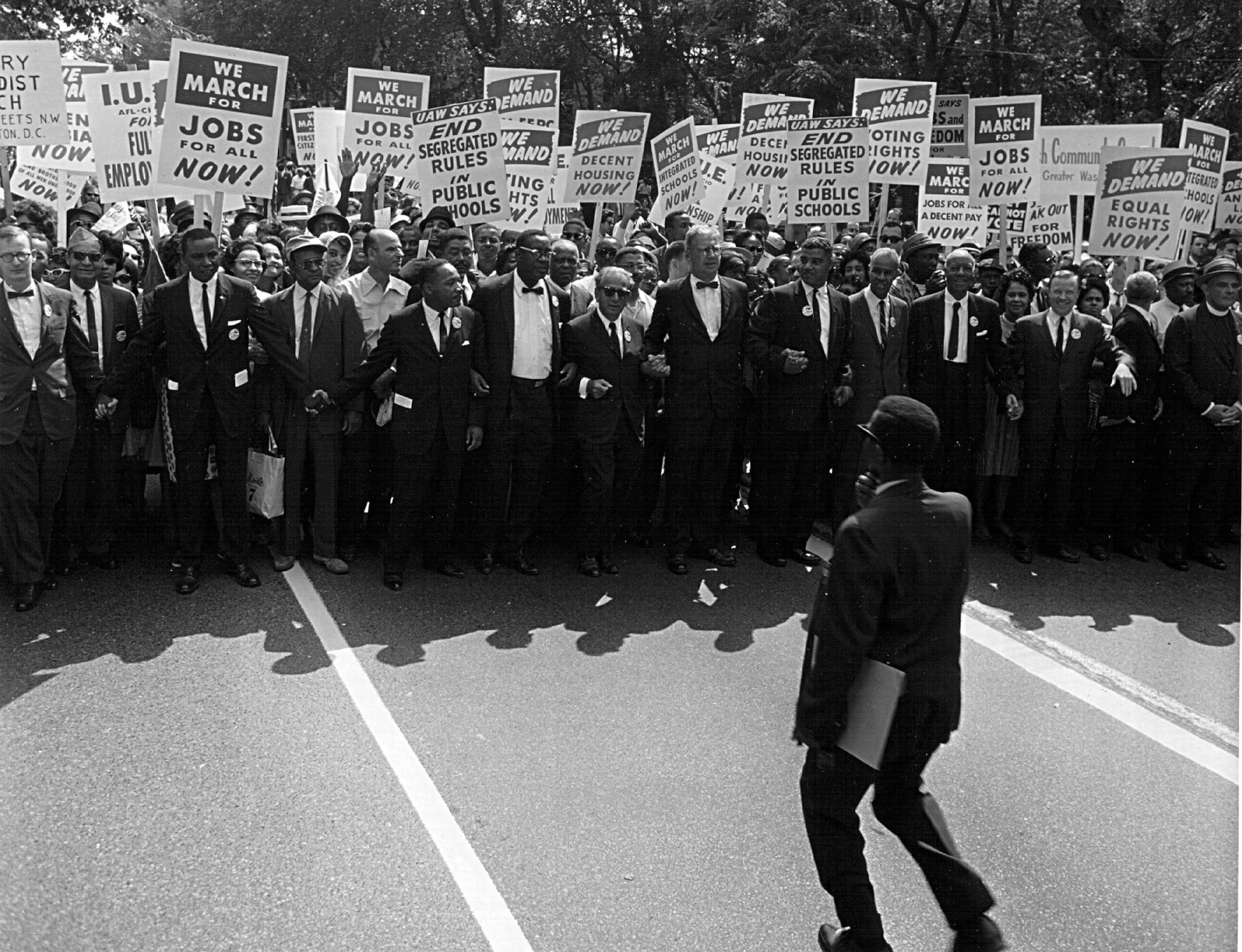 civil rights leaders marching in Washington with signs calling to end of segregation