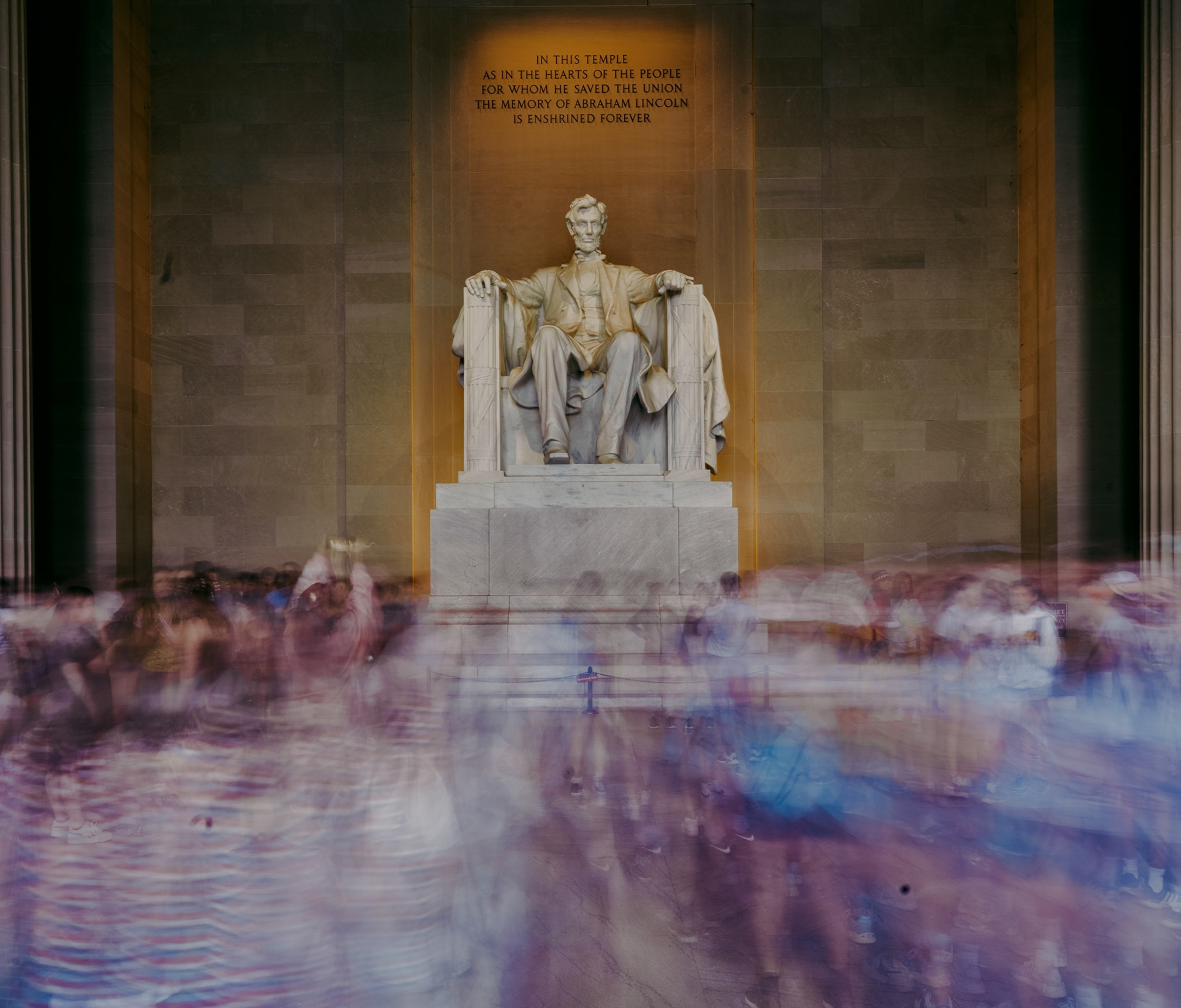 A slow exposure shows a blur of crowds inside the chamber and around the statue at the Lincoln Memorial