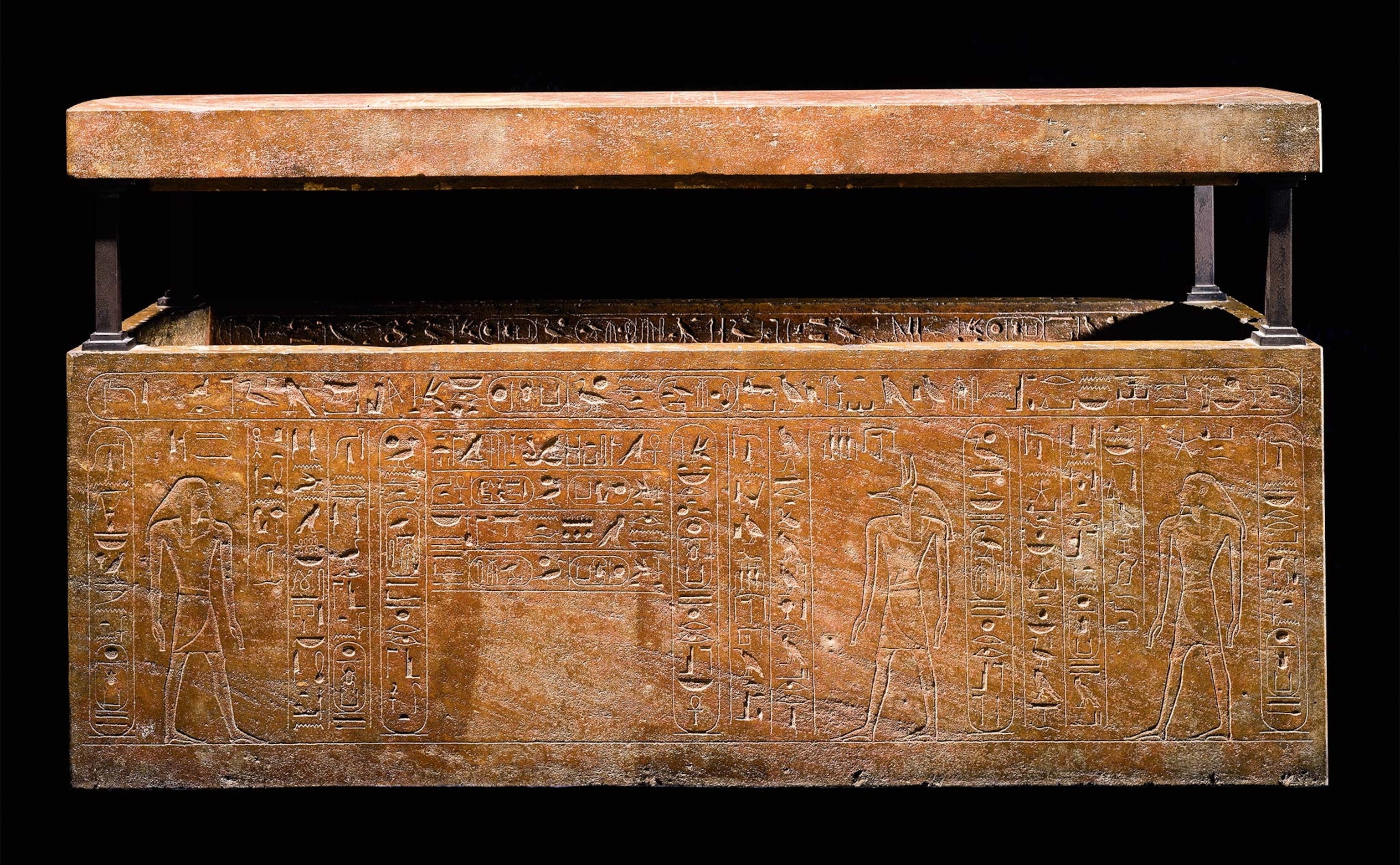 A side view of hieroglyphs on Hatshepsut’s brown stone sarcophagus