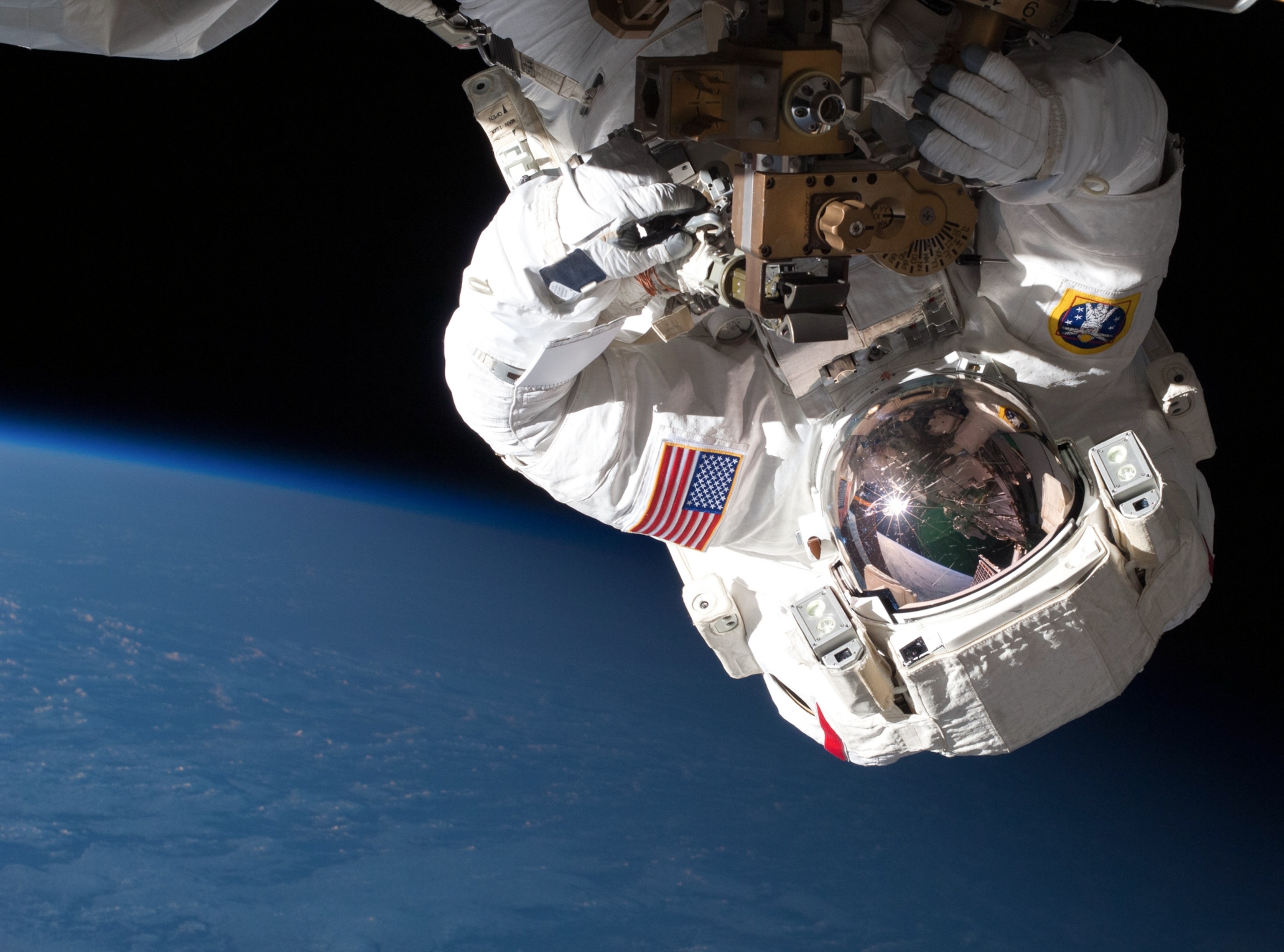 astronaut Chris Cassidy performing a spacewalk to repair a leaky pump on the International Space Station