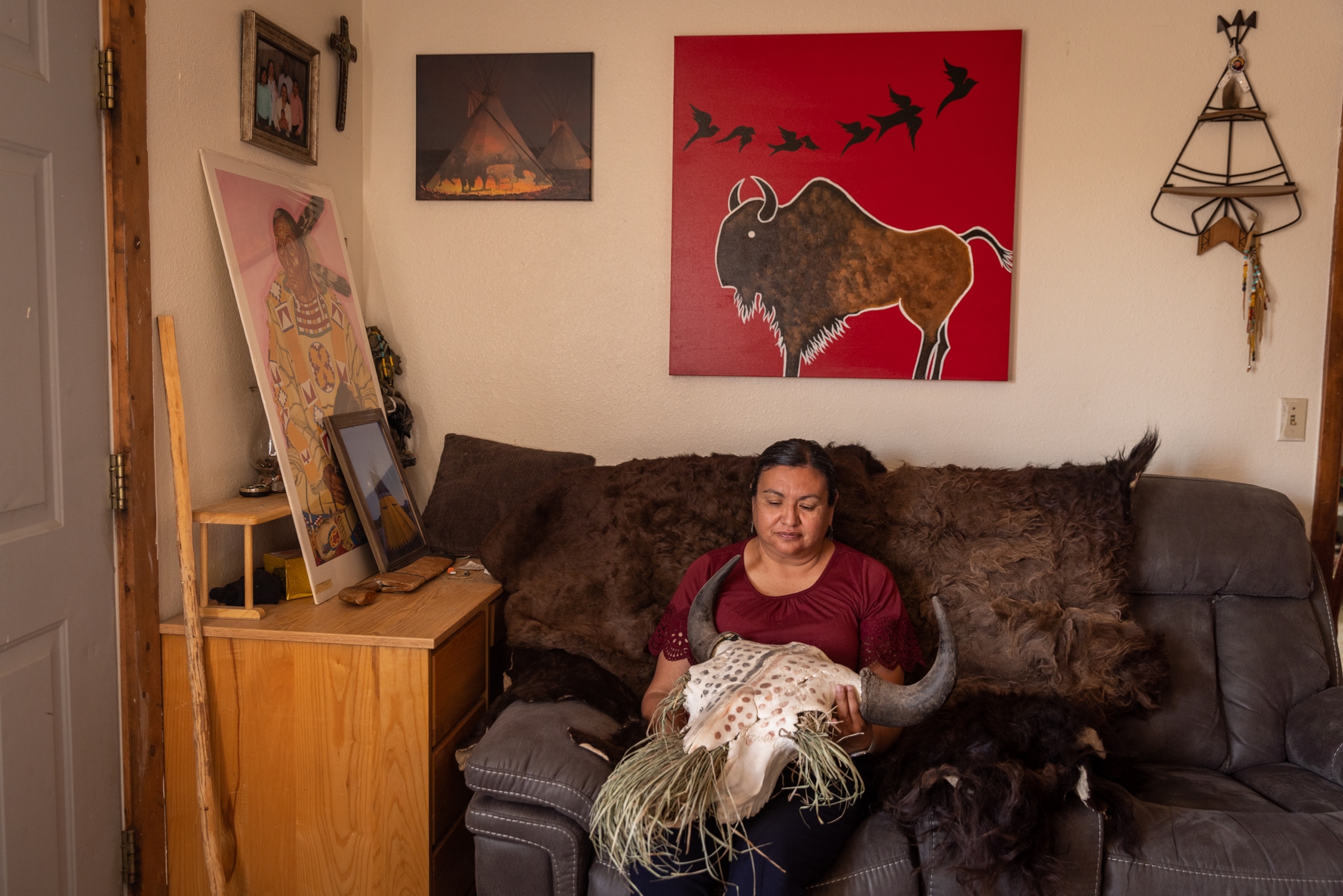 Helen Augare sits in her home in Browning, Mont., on a hide from a Blackfeet buffalo