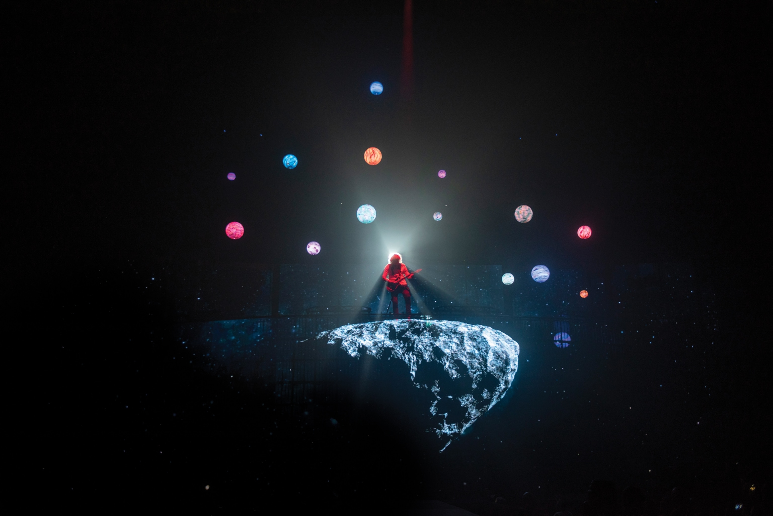 Musion standing on flying rock.