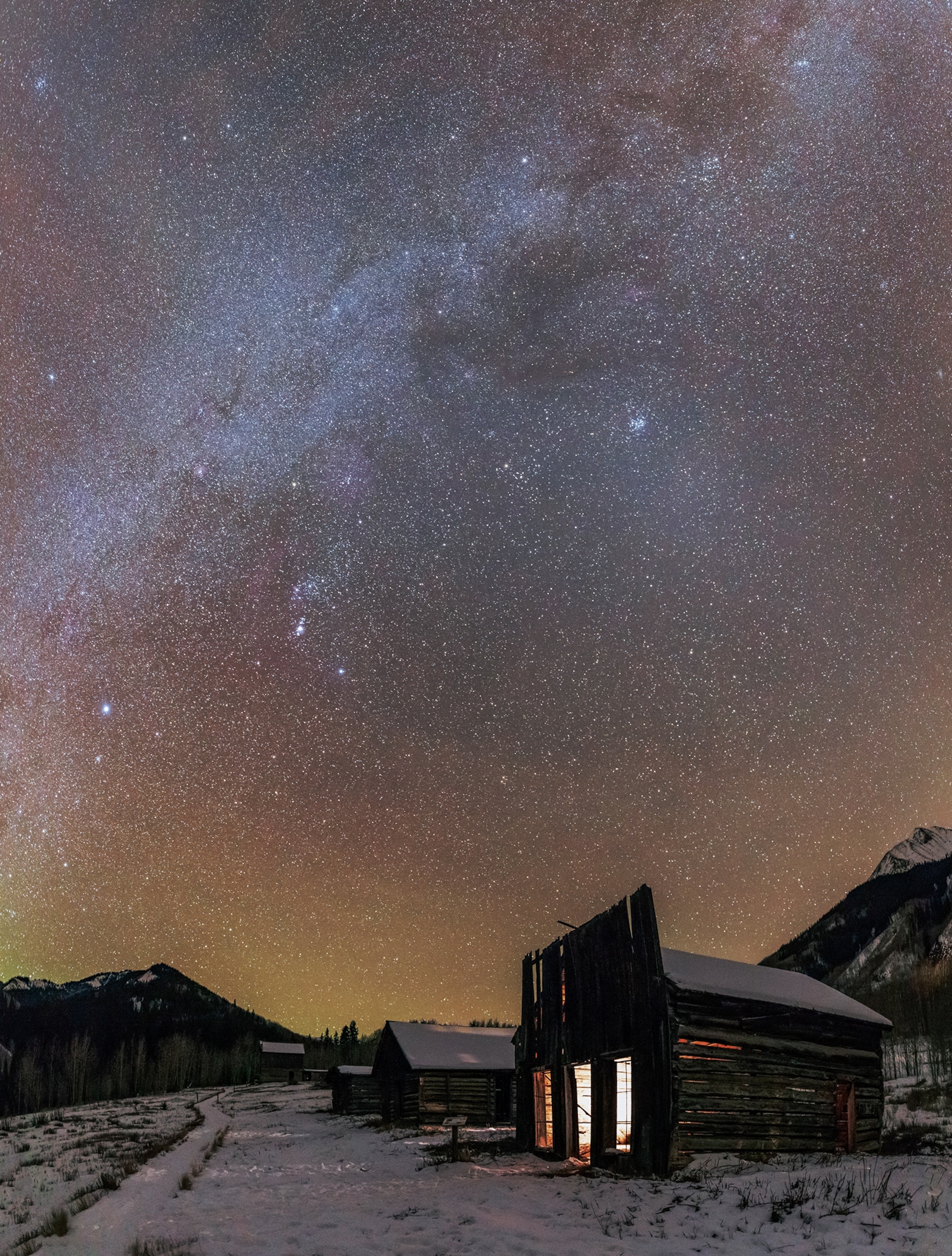 A cabin sits under the night sky.