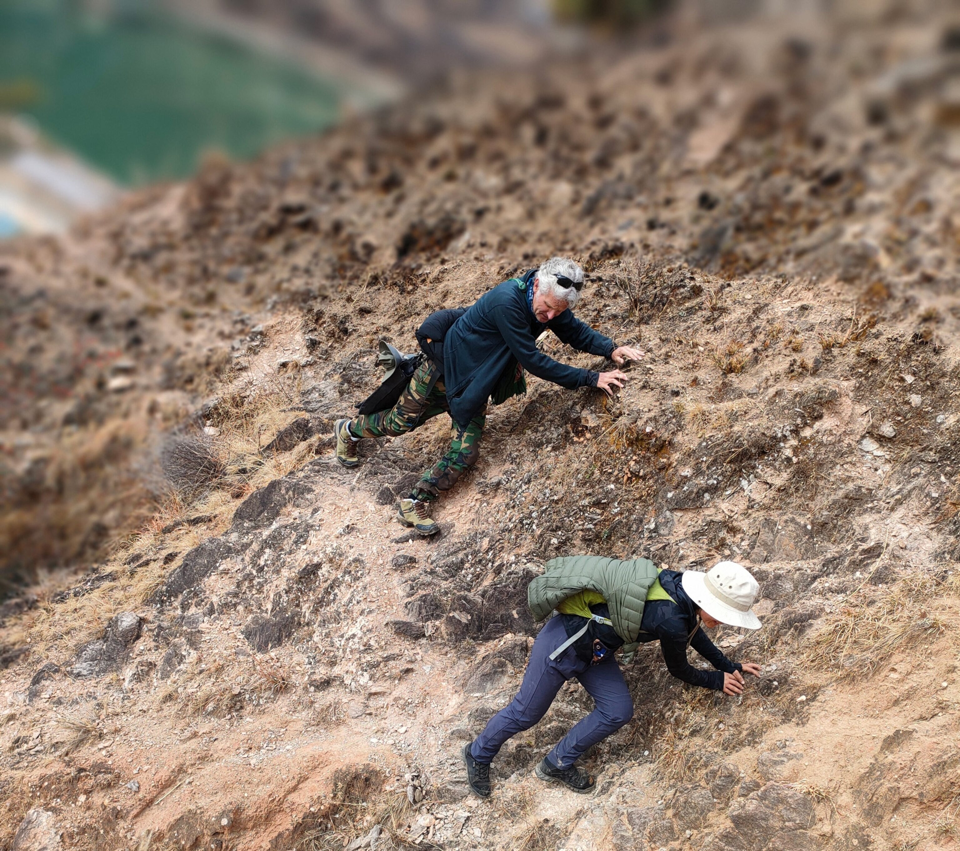 Photo of two men climbing rocky terrain.
