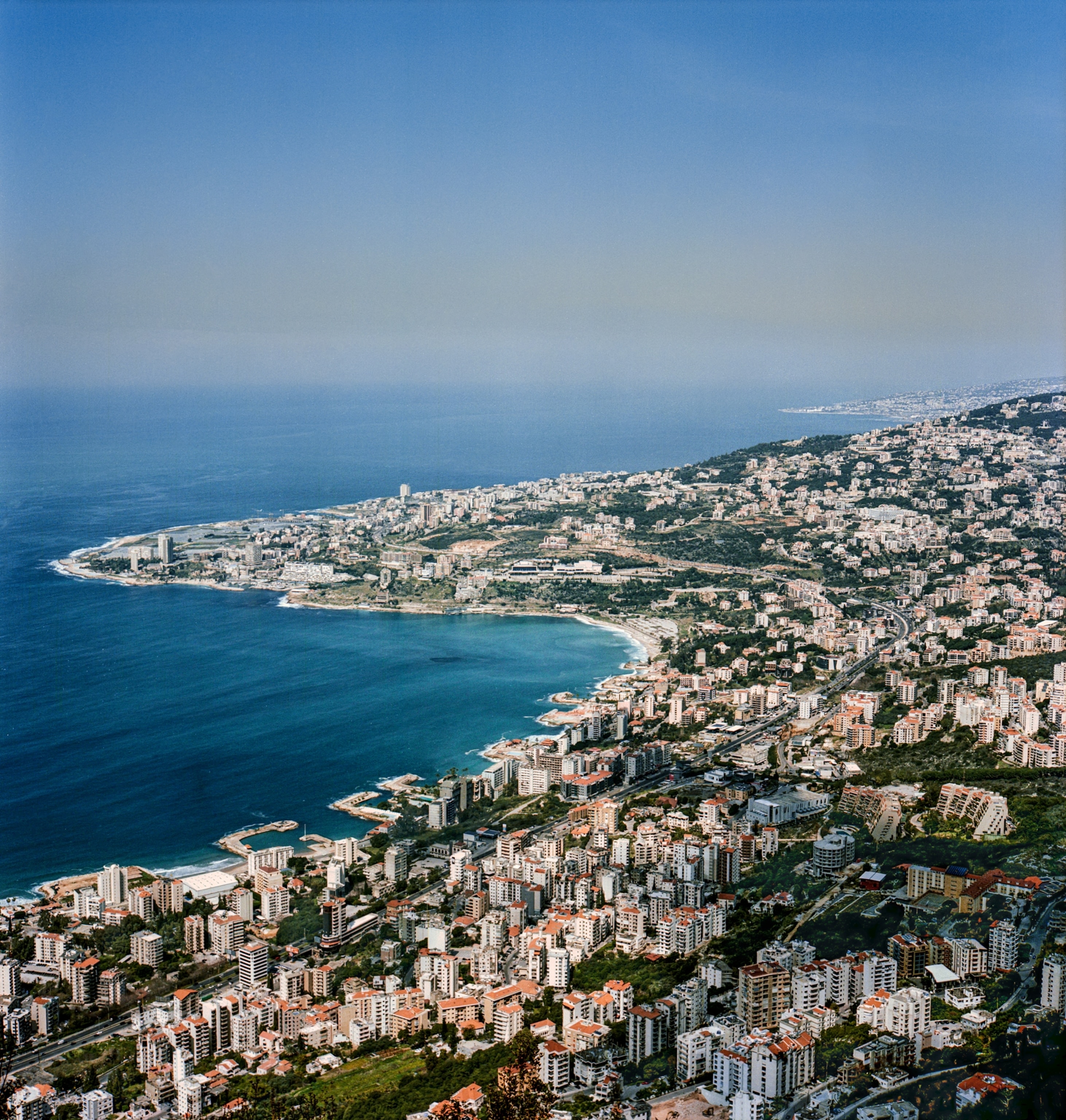 Picture from a high view of the coastline of the Bay of Jounie in Lebanon, filled with buildings all the way up to the coastline.