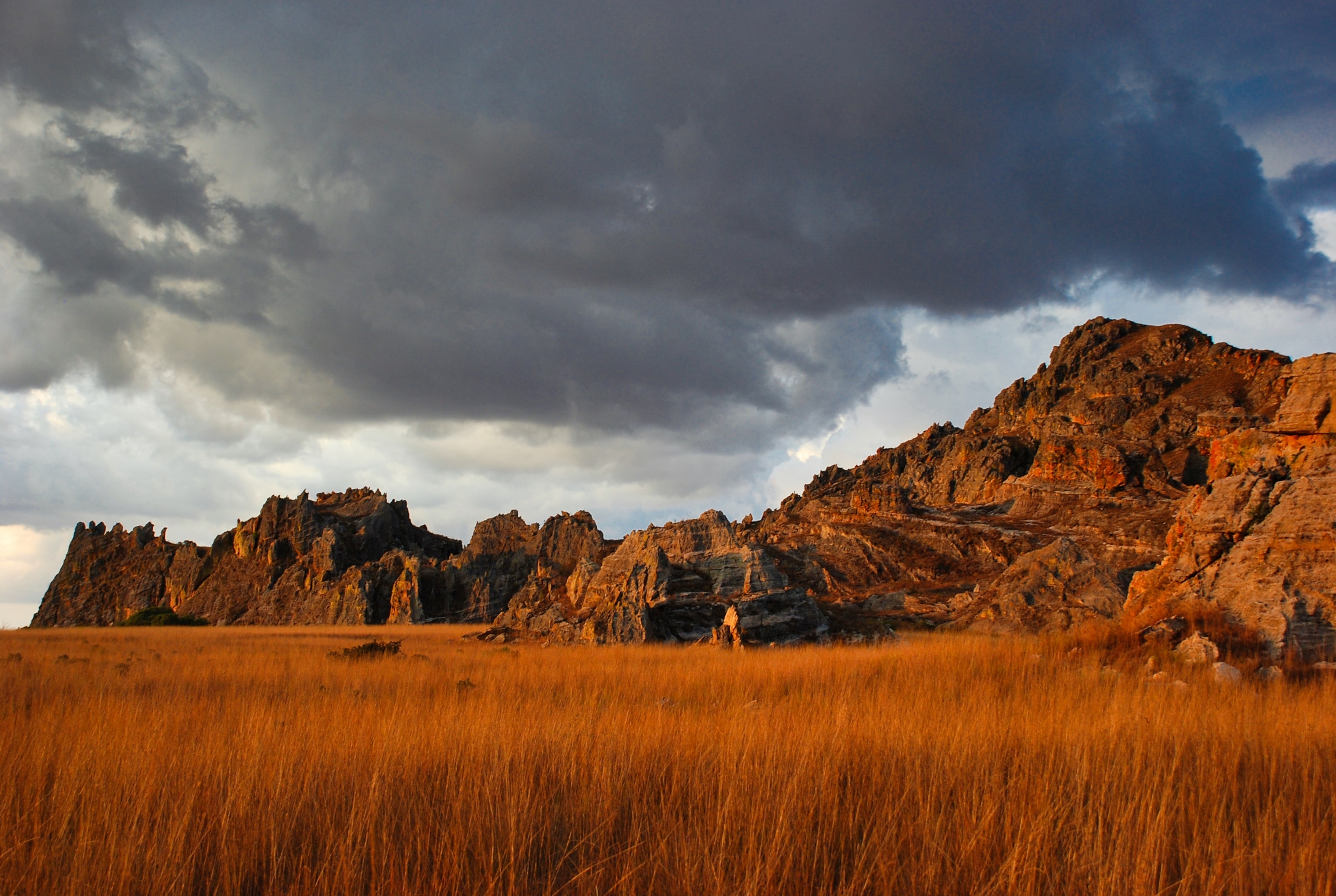 Rocky sandstone formations lit by the golden glow of sunset.