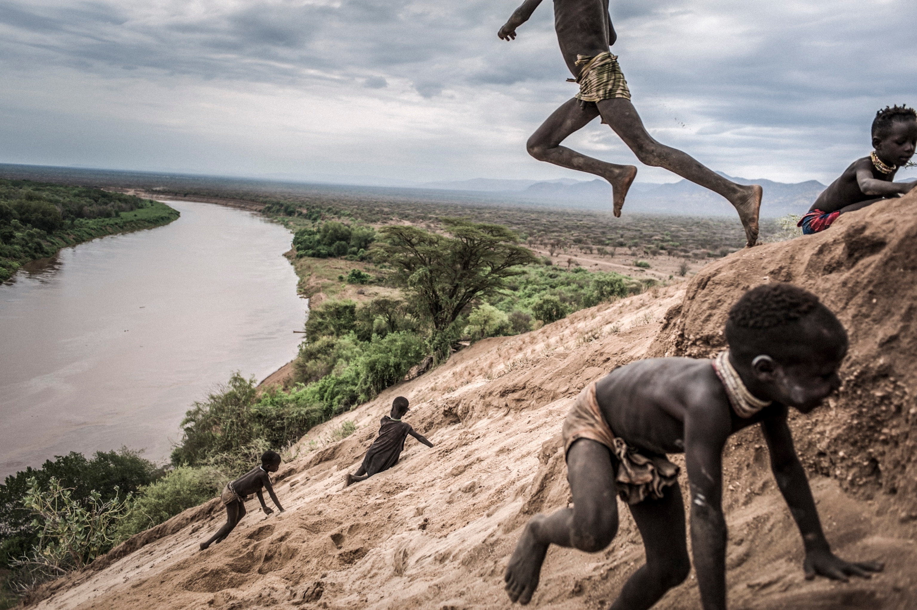 children playing along the shores of the Omo River