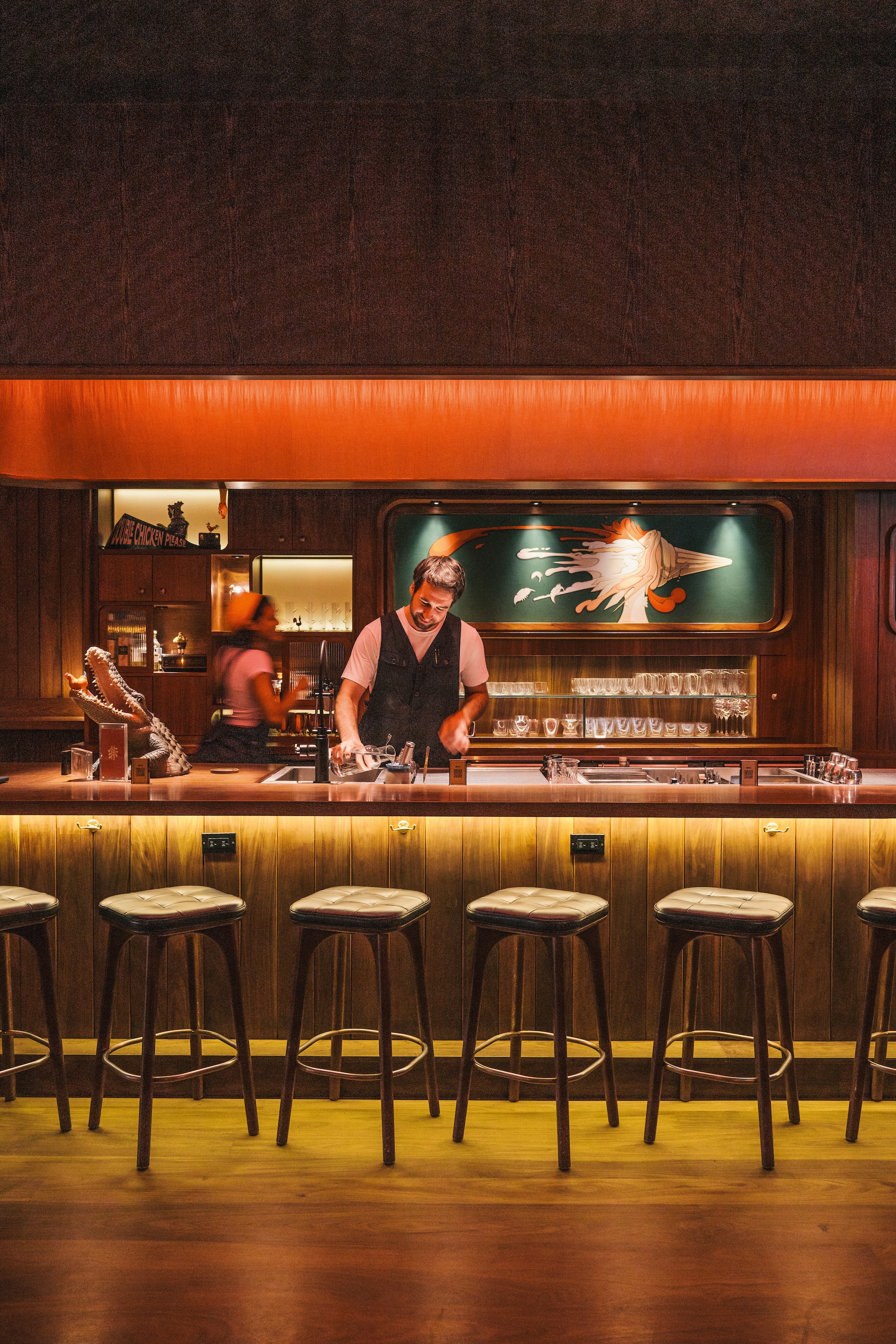 bartenders behind soft pink bar