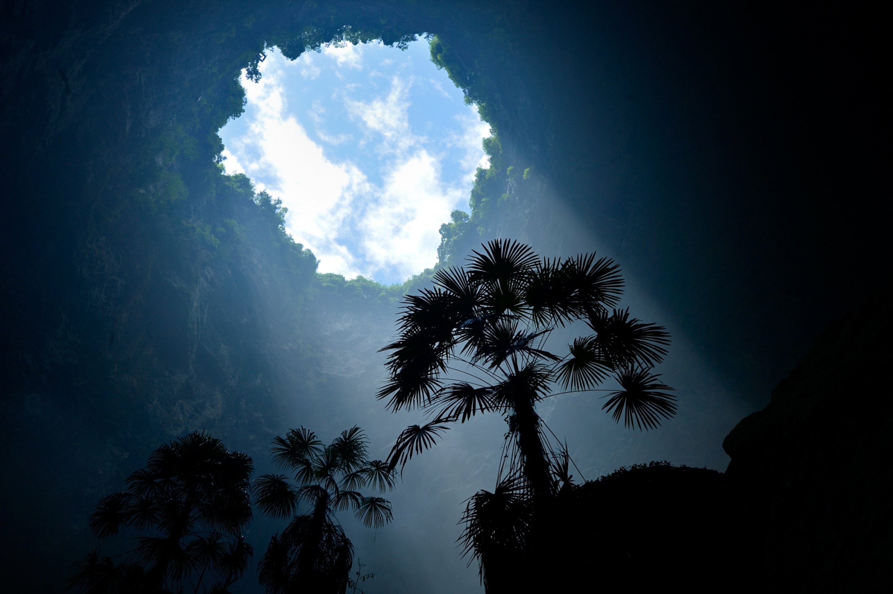 Sunlight touches the plants inside a sinkhole in the mountainous Xuan'en County, central China's Hubei Province