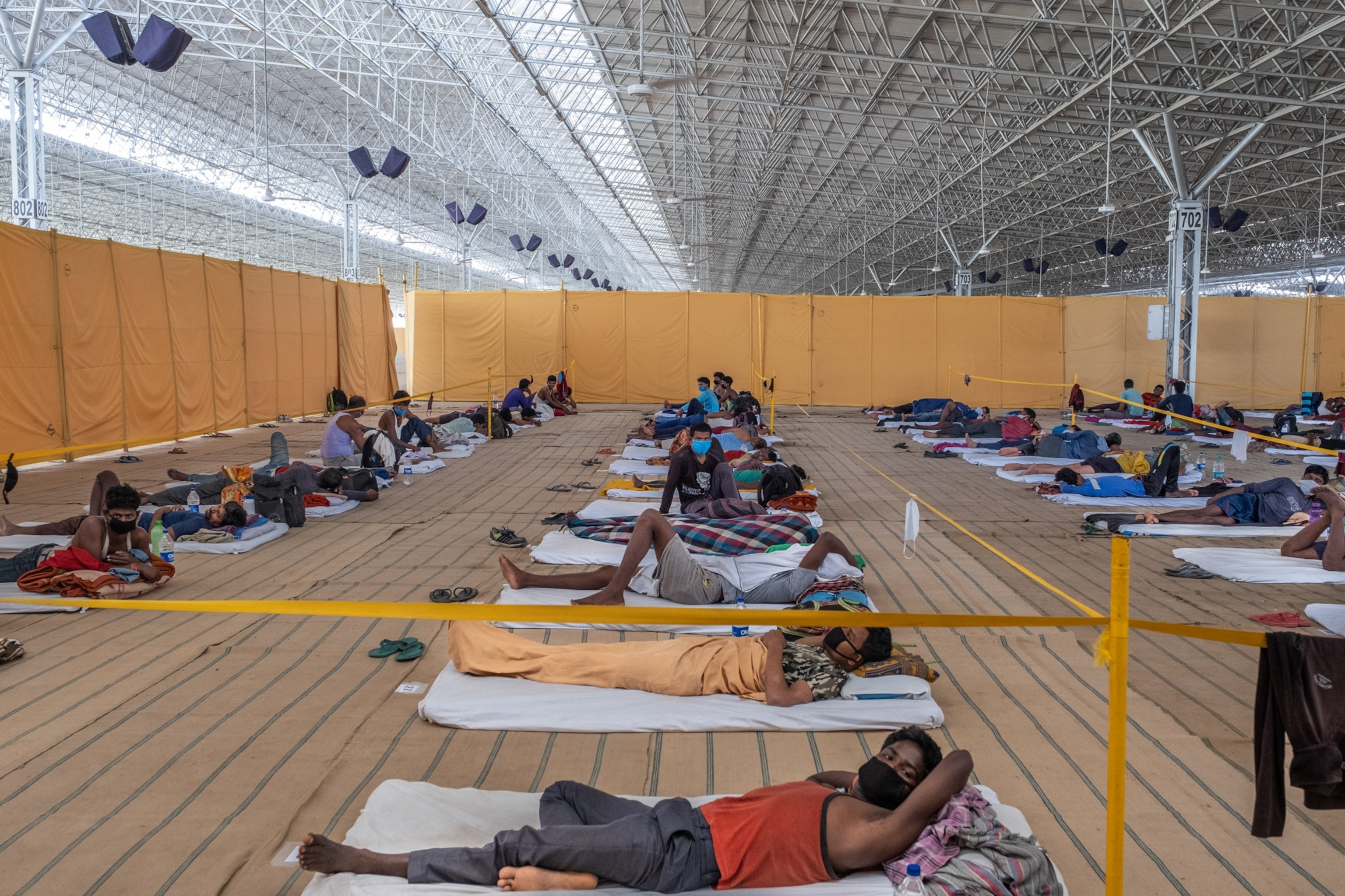 many people lying down in a large open room