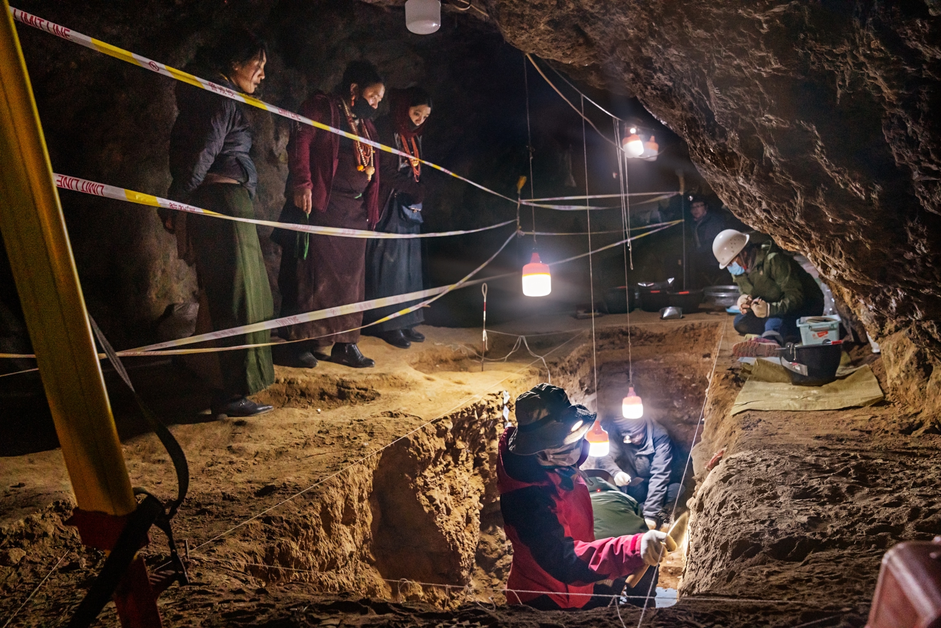A team of people working inside of a cave.