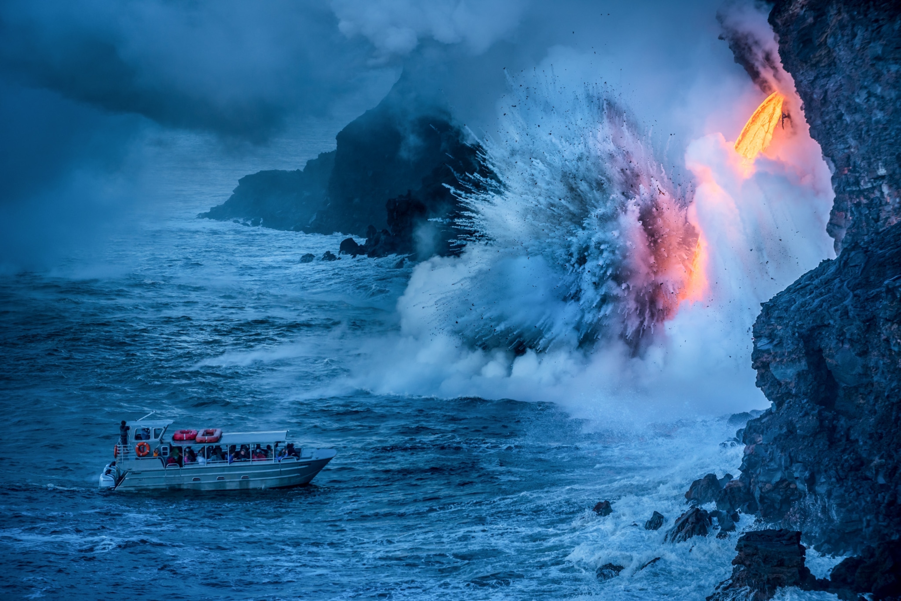 a ship along the lava falling coast of Hawaii Volcanoes National Park, Hawaii