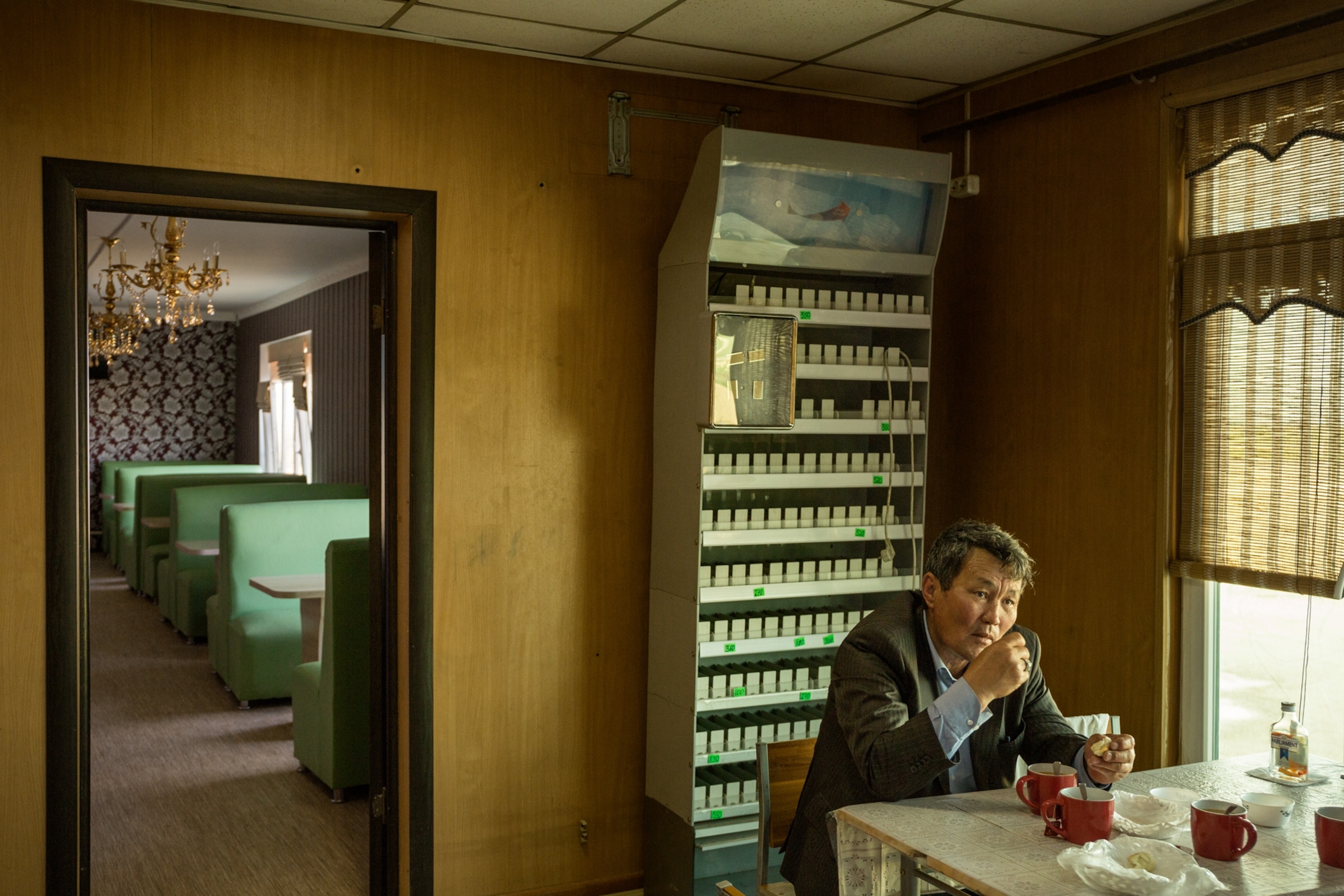 a man at a truck stop diner in Uzbekistan drinking tea