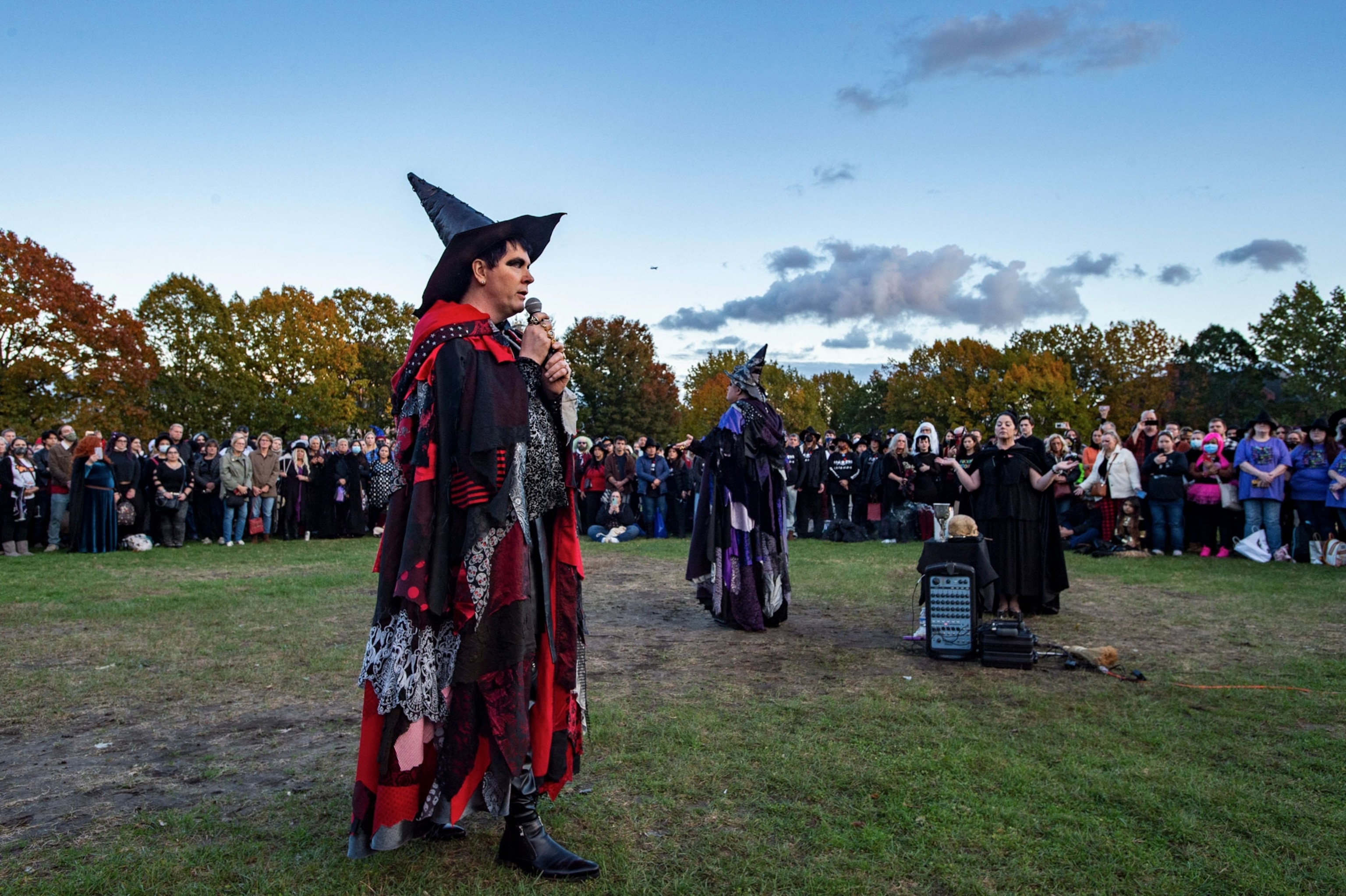 a large group of modern witches conduct a ceremony outside in Salem, Massachusetts on Halloween