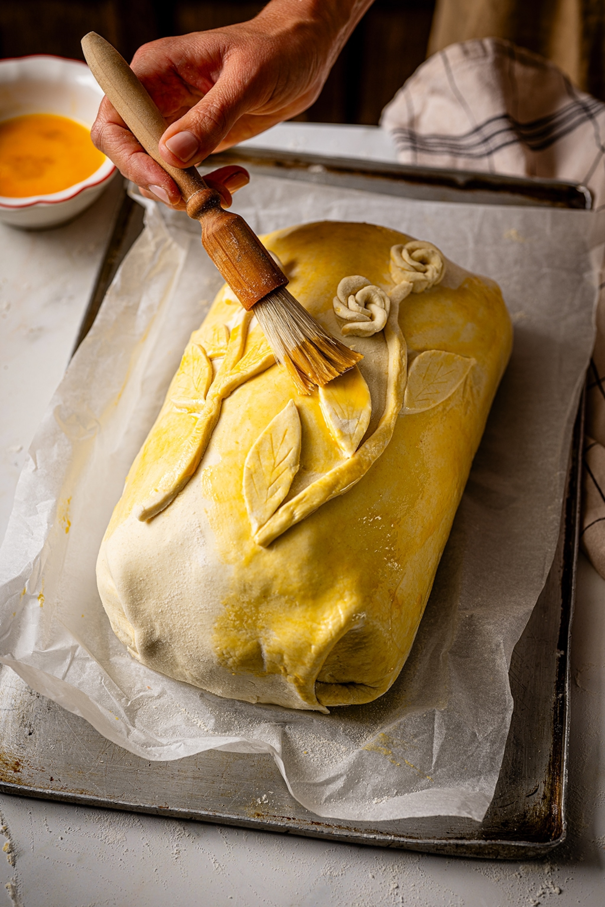 Brushing pastry with egg yolk