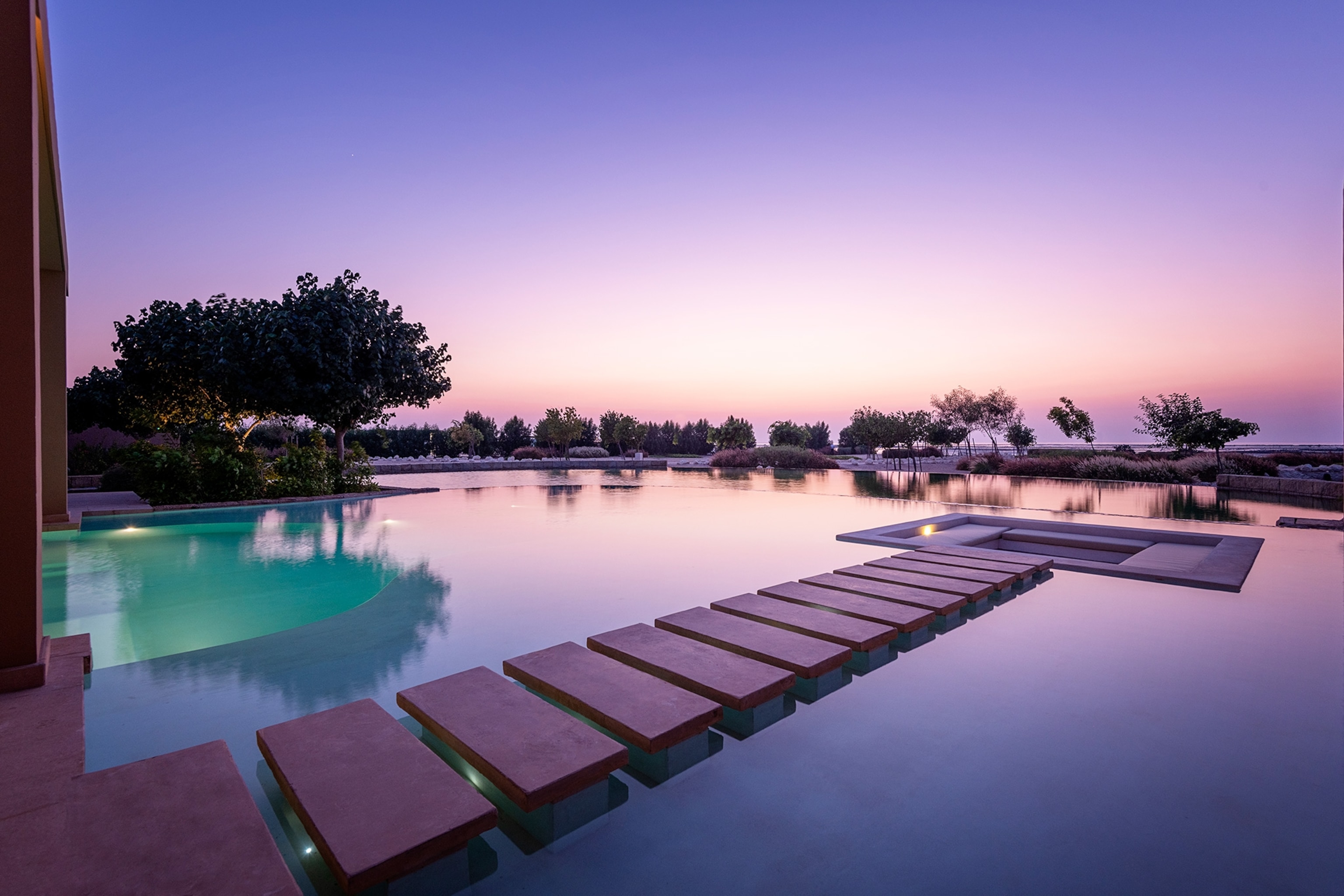 Photograph of the Zulal Serenity – Balcony at Qataf Suite with a view of the water at twilight.