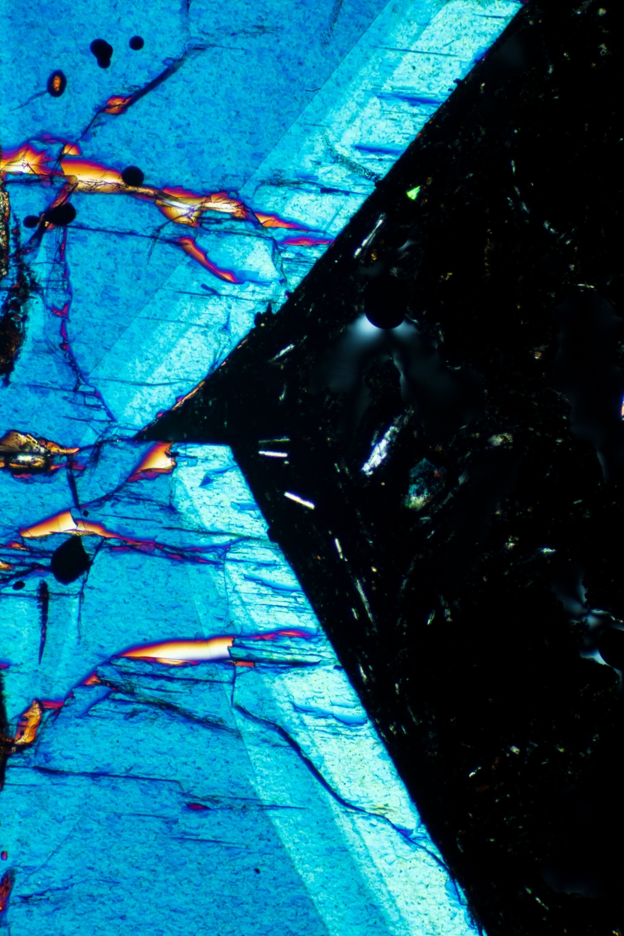 A sample of pyroxene, which appears iridescent blue and jagged, almost like the edge of a razor