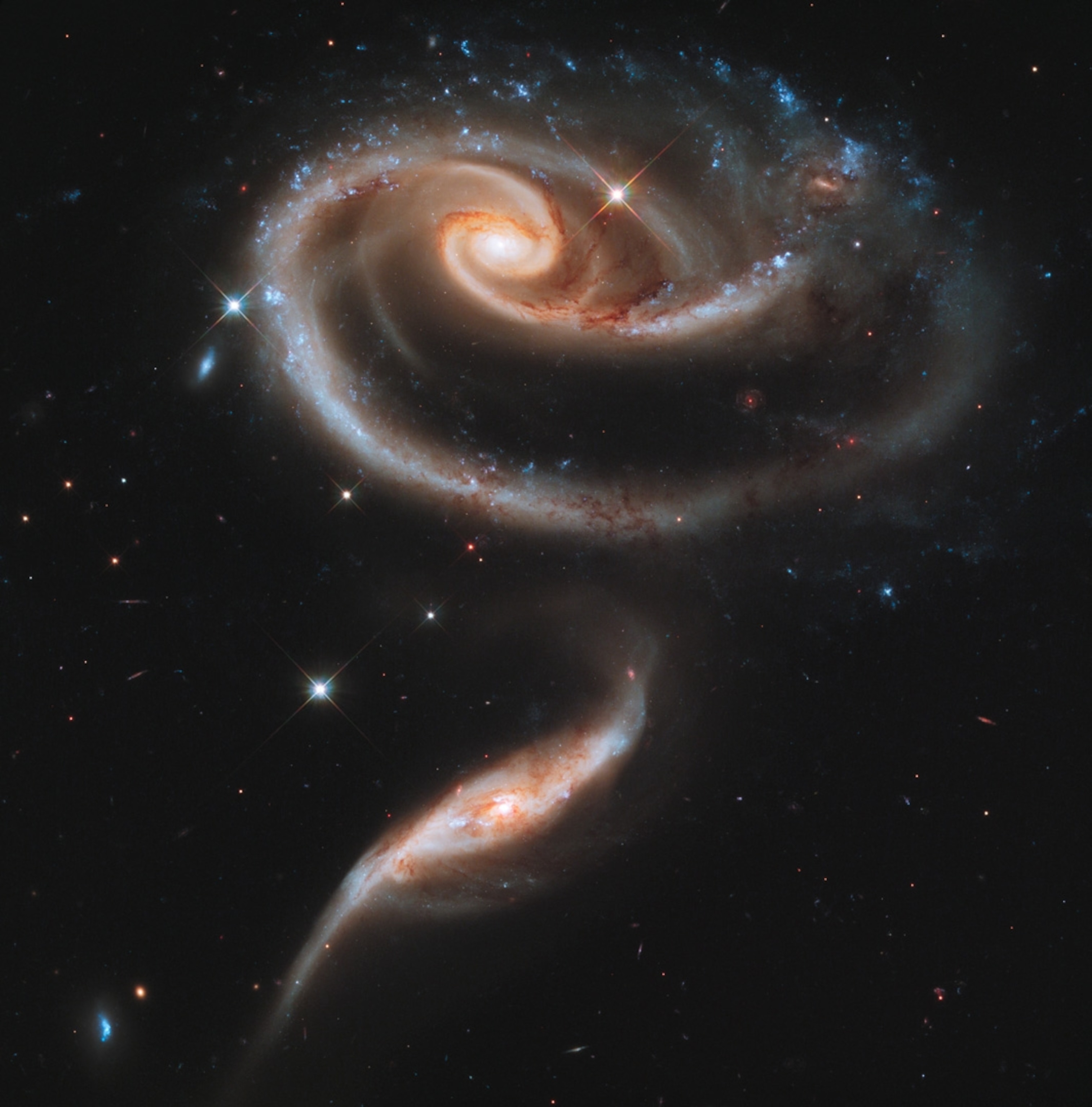 interplay of their gravitational forces bends two spiral galaxies, known as Arp 273