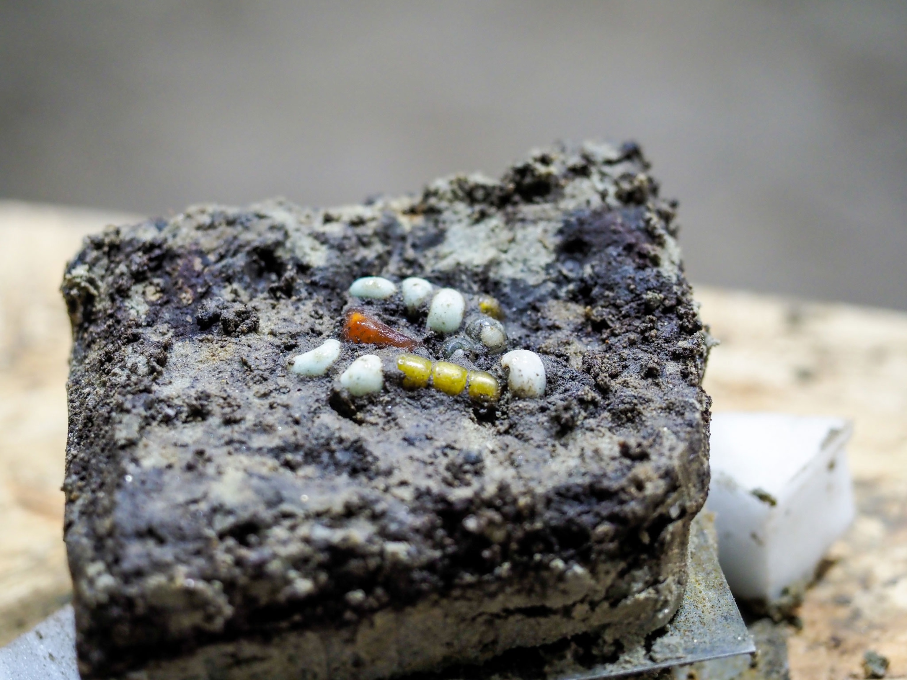 A block of soil contains a collection of smaller beads