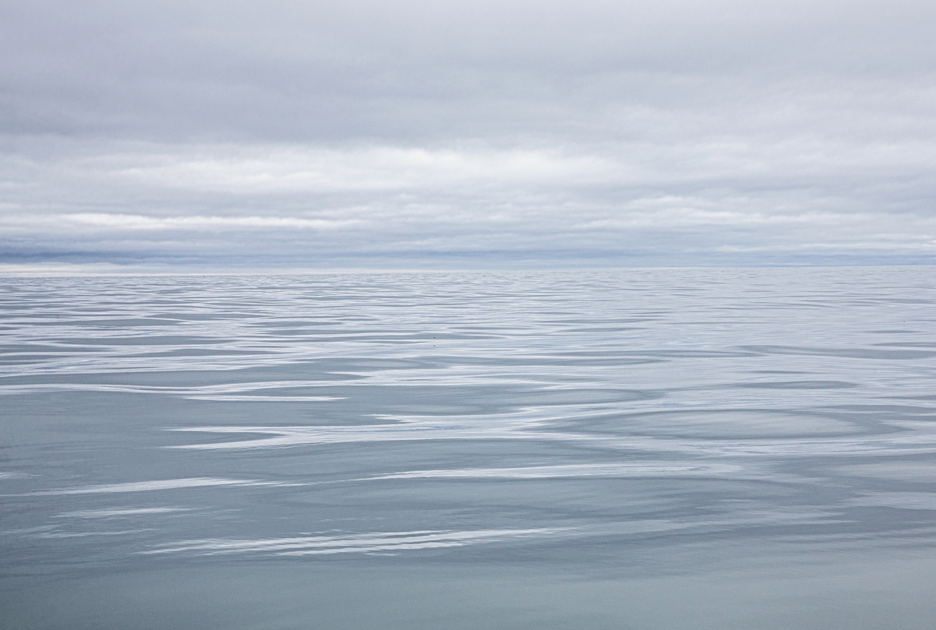 blue-gray seascape with low clouds.