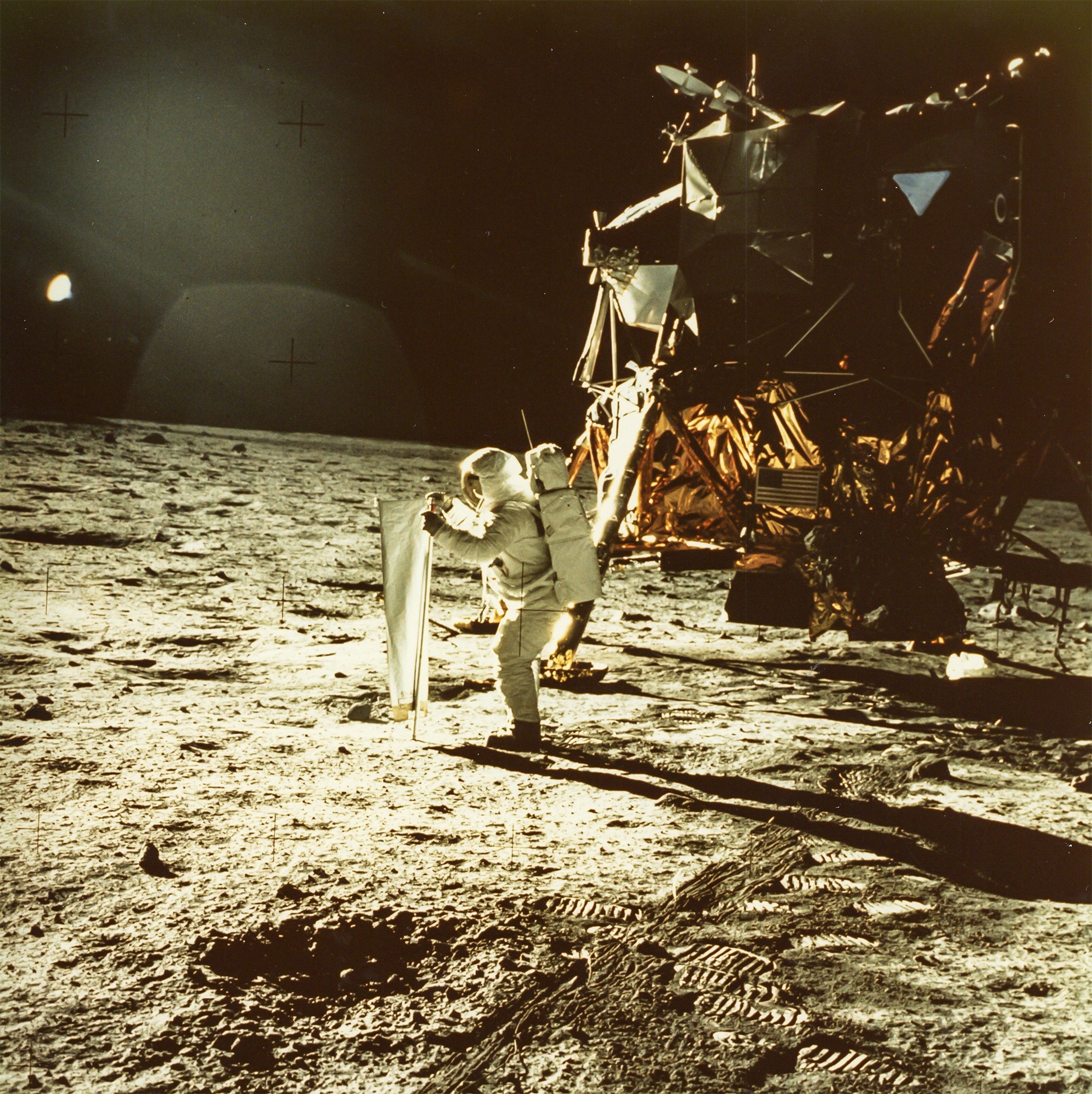 Buzz Aldrin taking his first steps on the moon in 1969