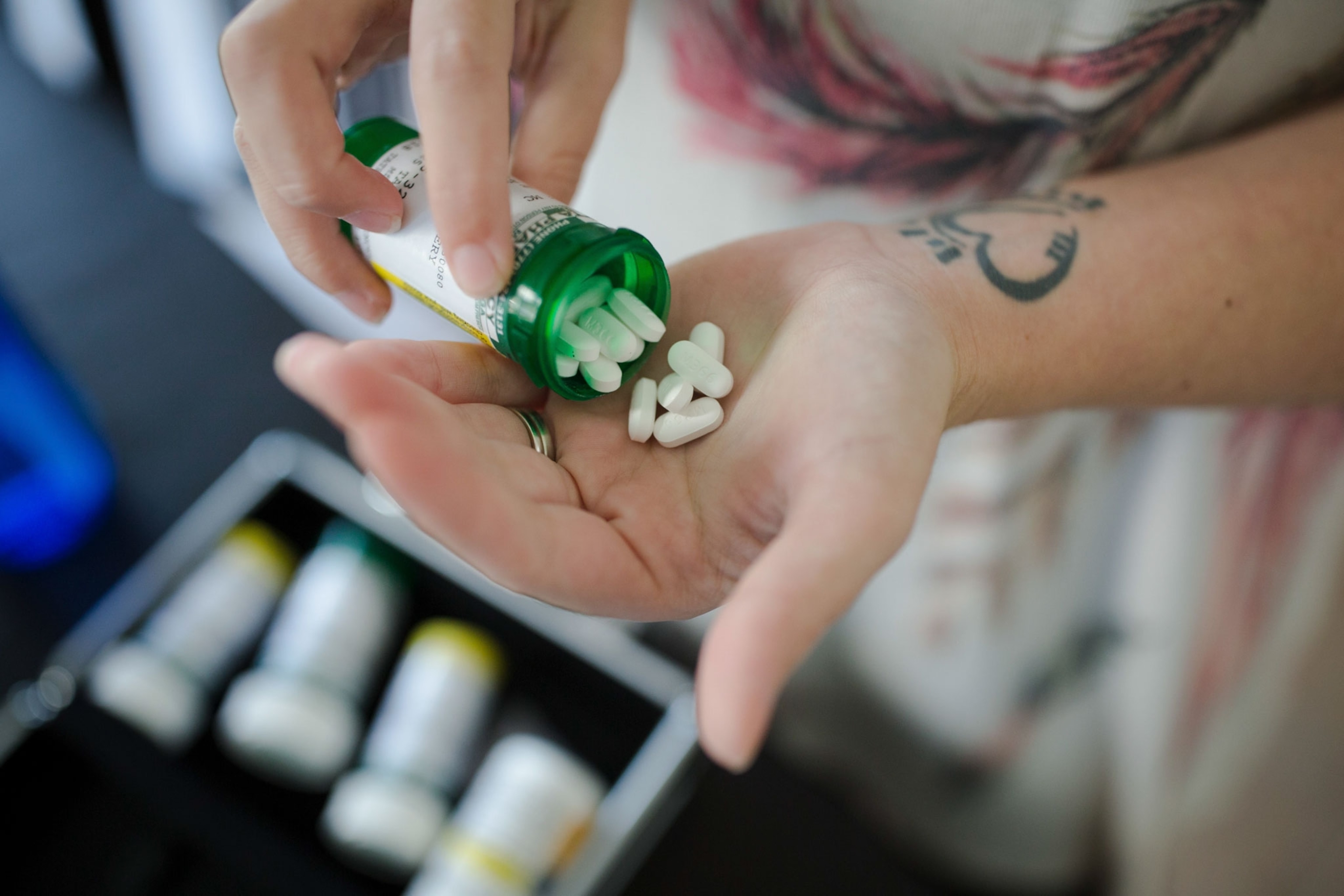 a person pours hydrocodone pills into their hand